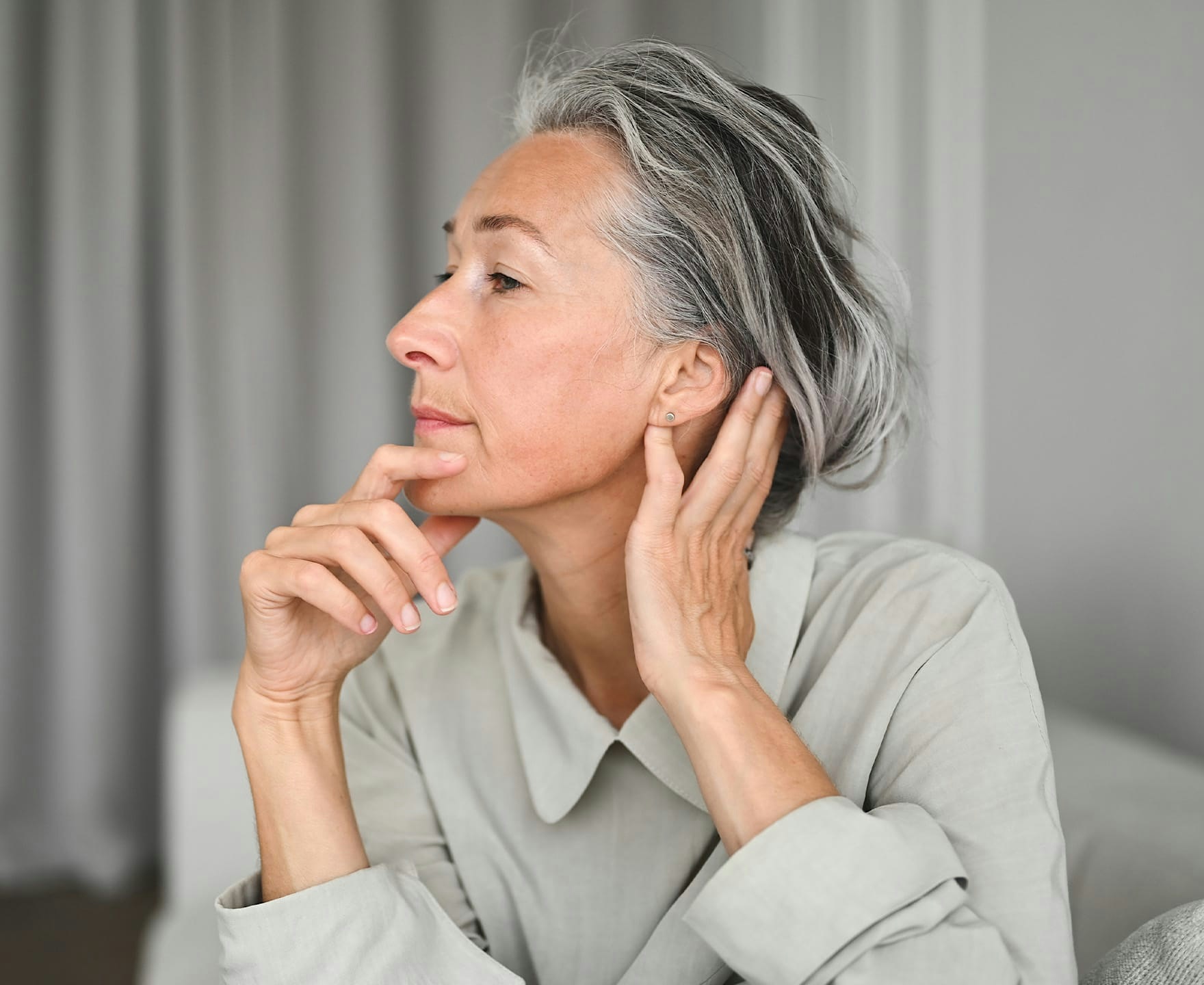 woman resting chin in hand