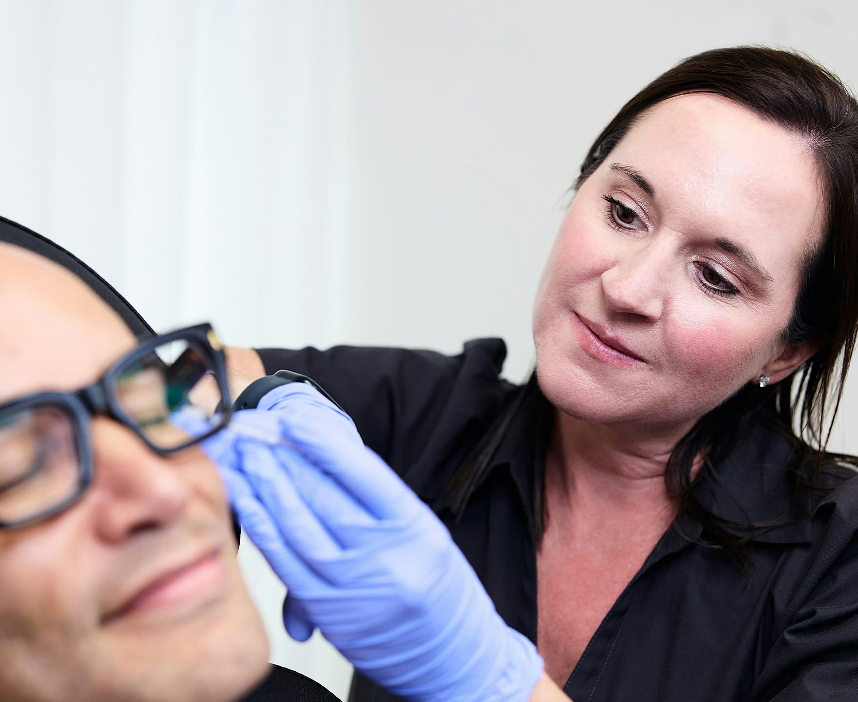 practitioner administering skin treatment