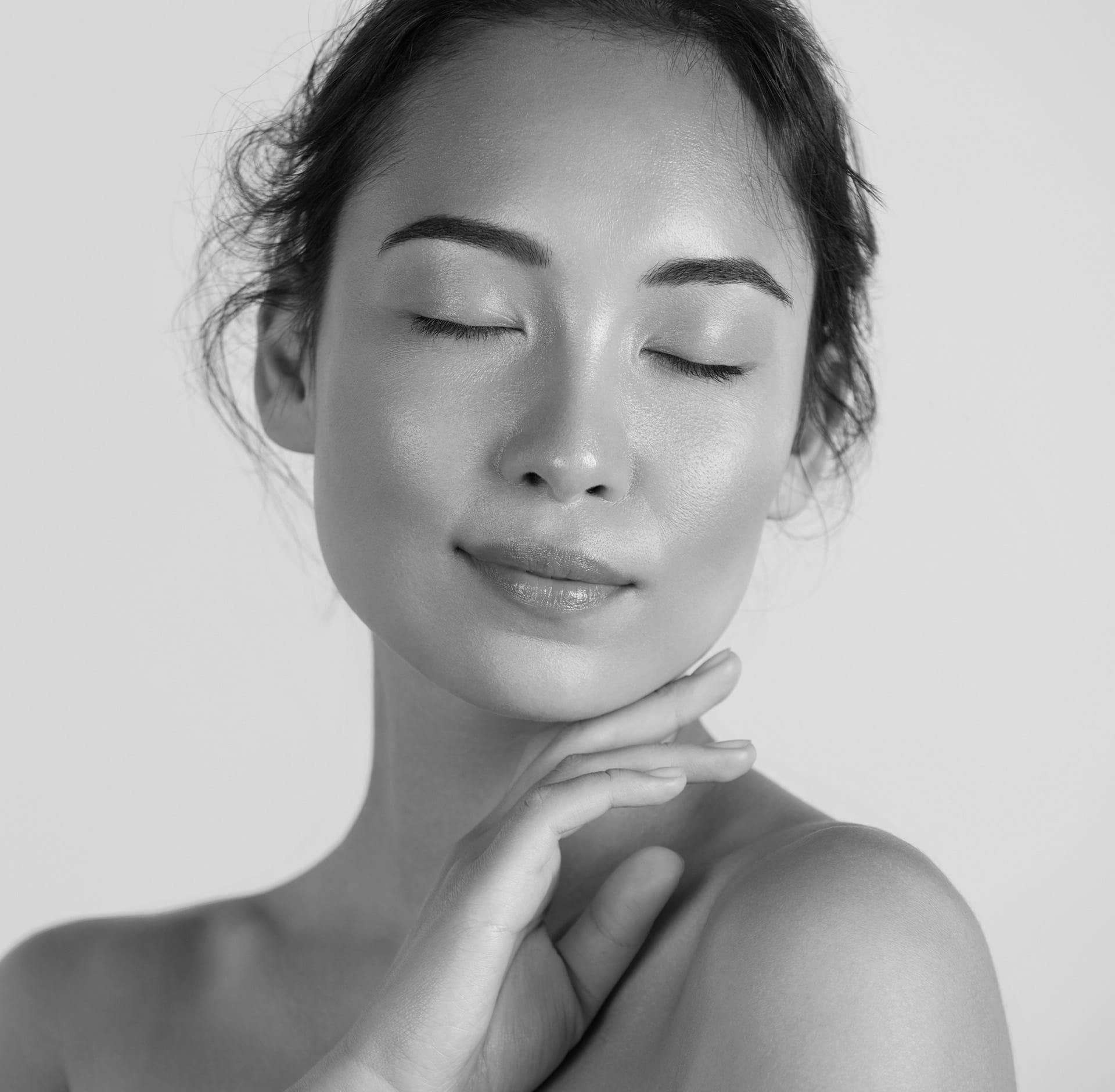 Woman posing with fingers on cheek