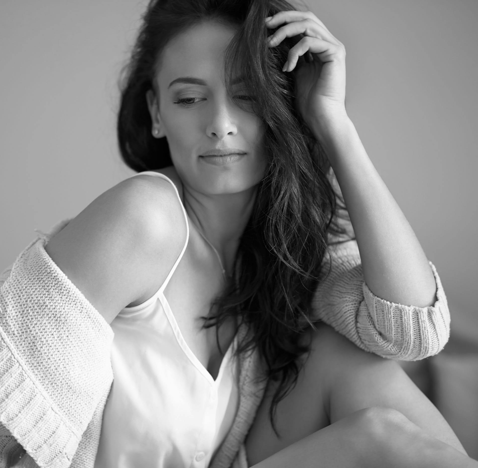 Woman with sweater draped over her shoulders