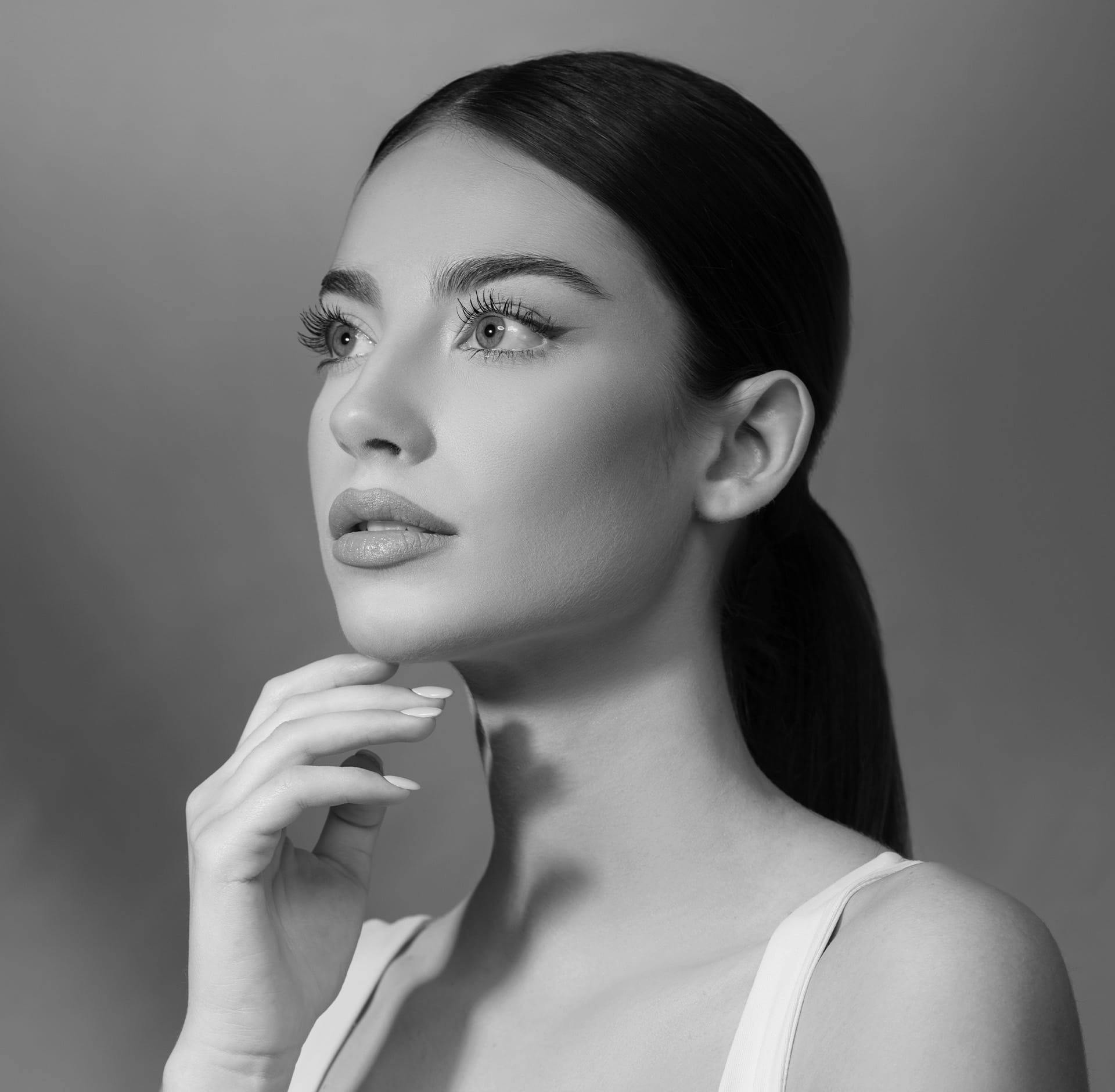 woman resting finger on chin