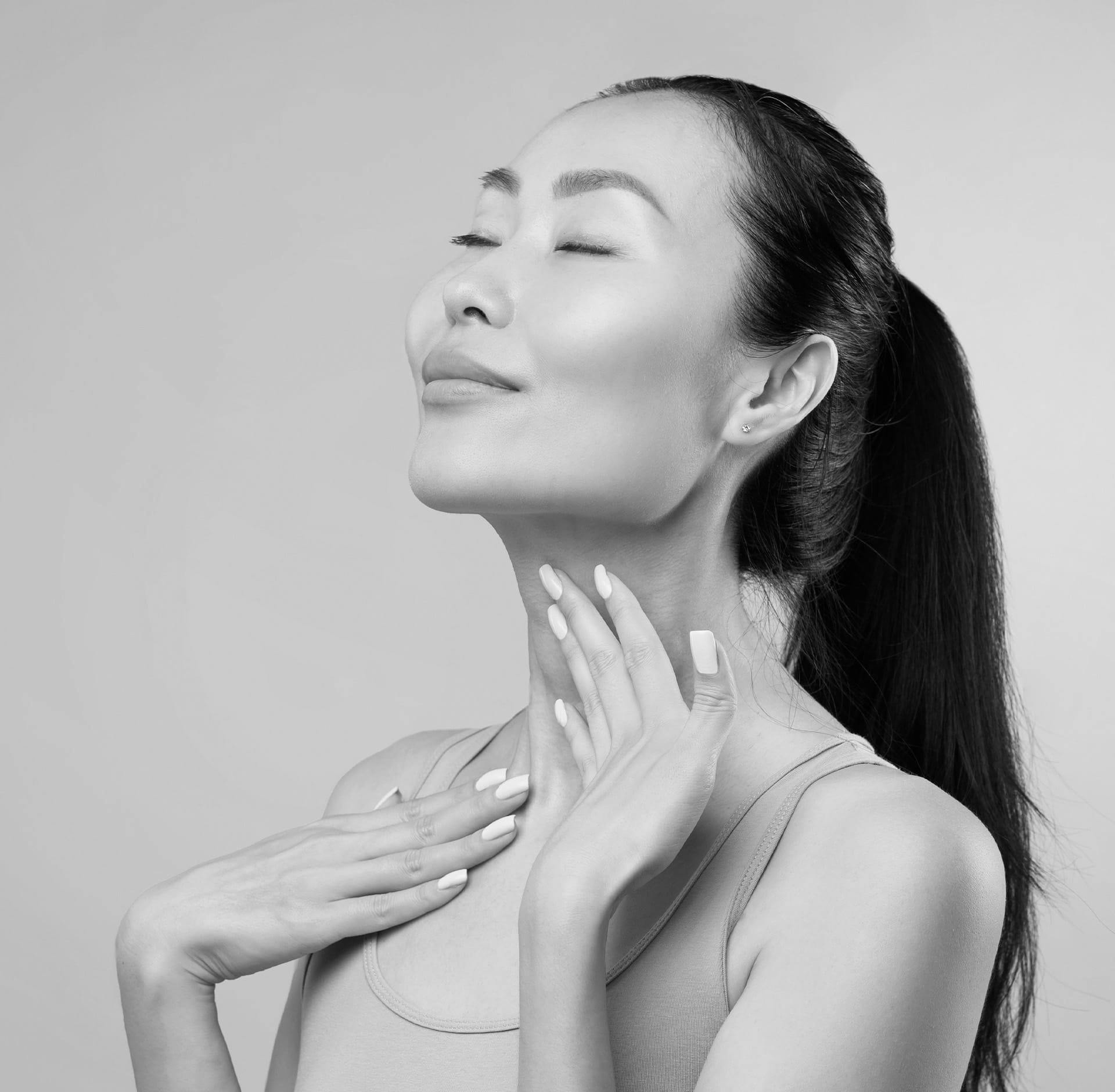 Woman running hands over her neck