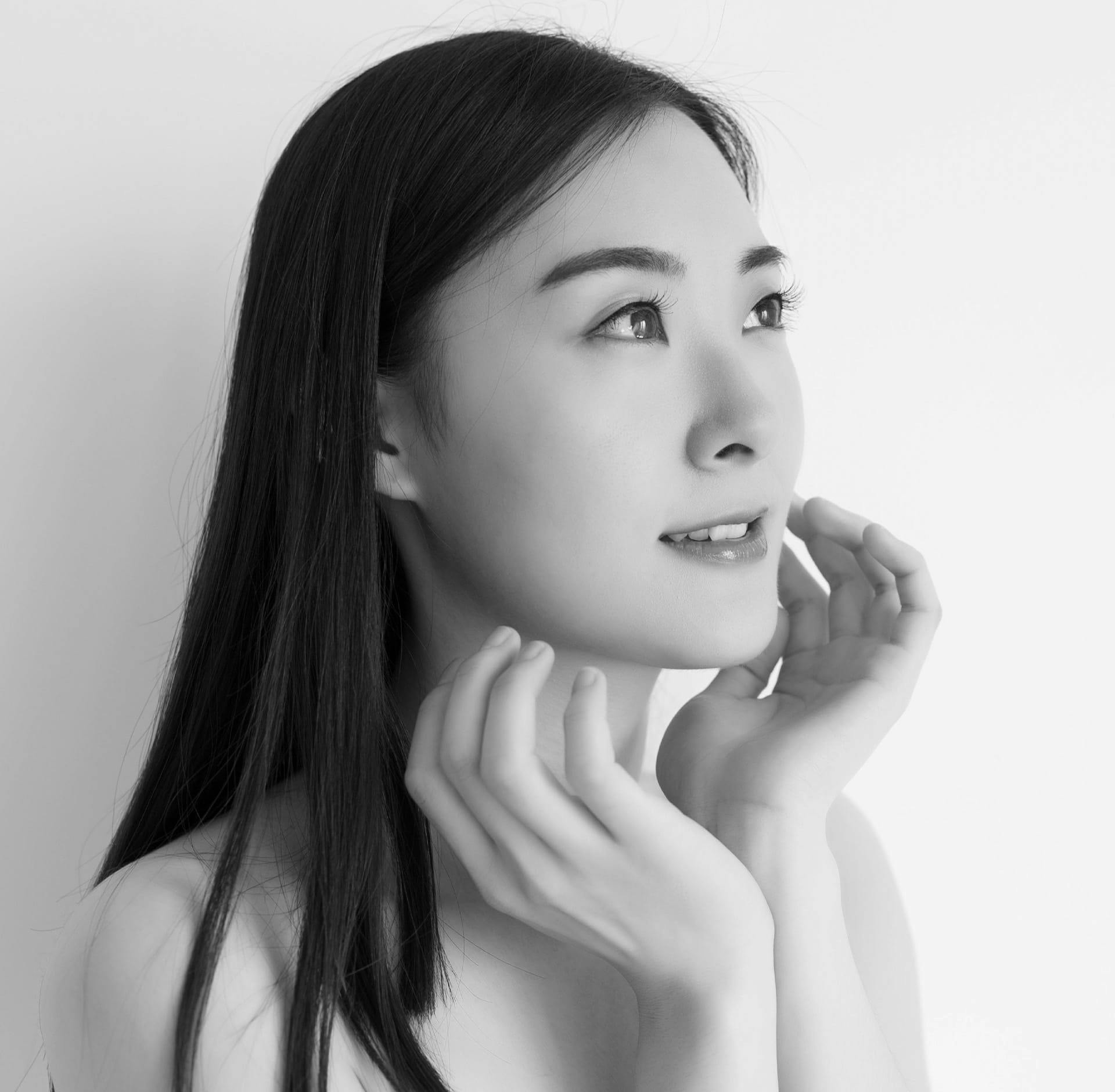 Woman posing with fingers on cheeks