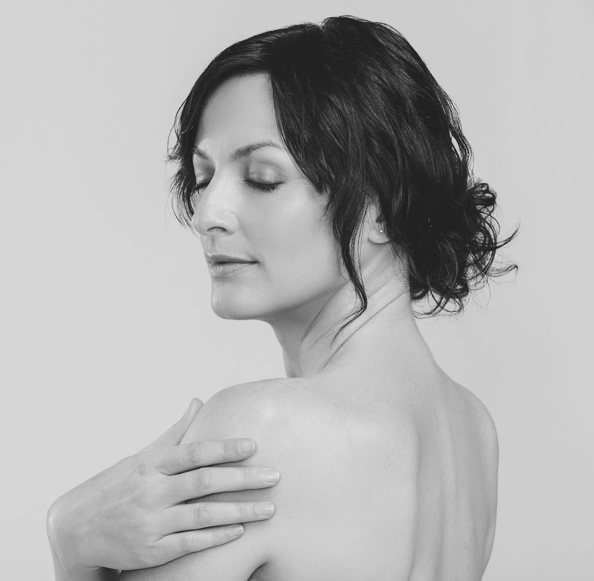 Woman running hand over shoulder