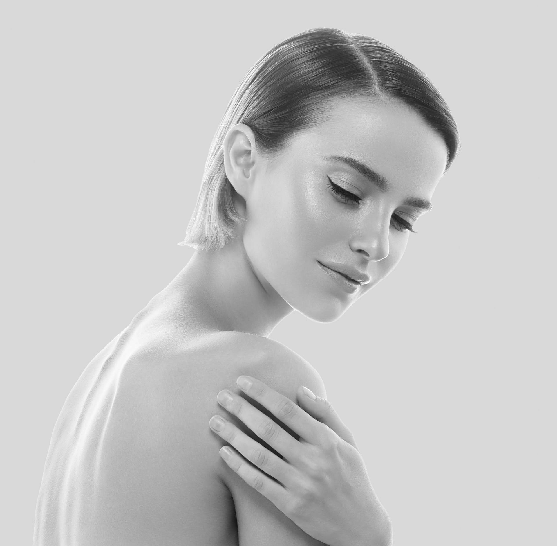 Woman holding her shoulder