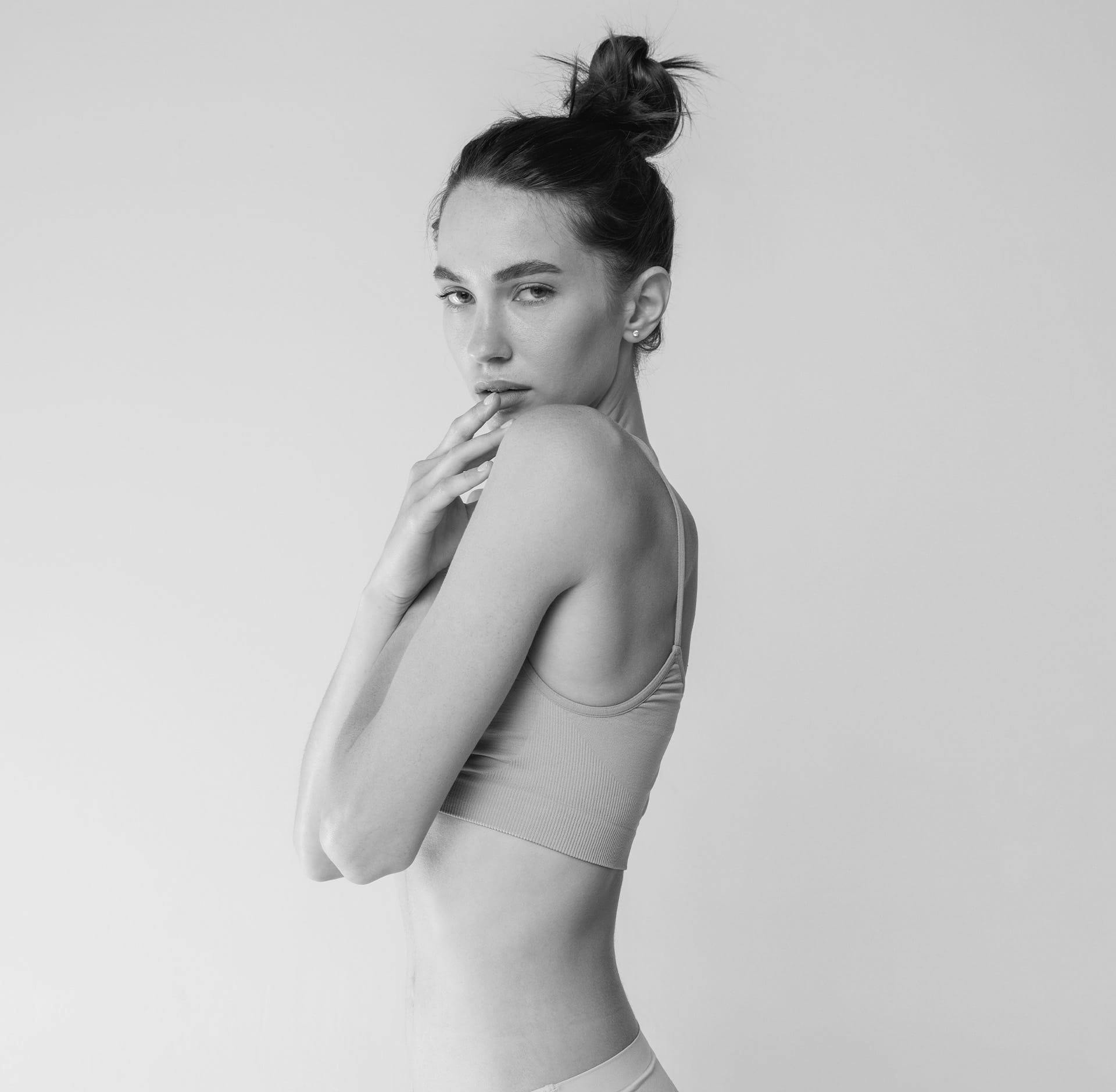 Woman posing with arms over breast