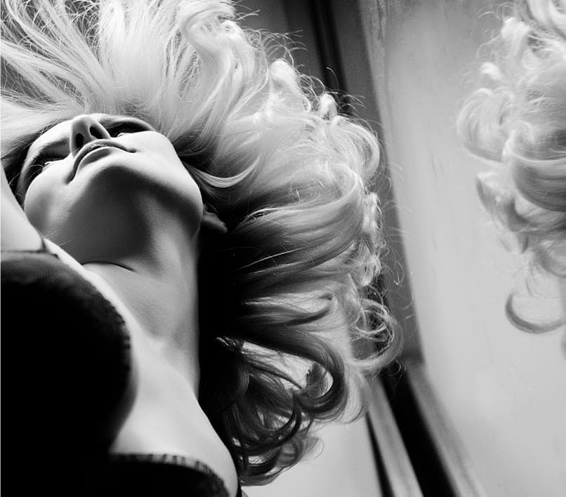 black and white image of a woman with curly hair