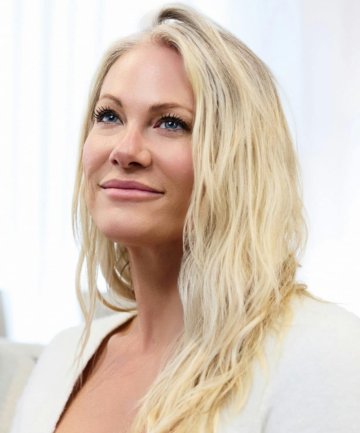 Woman with blond hair, looking up