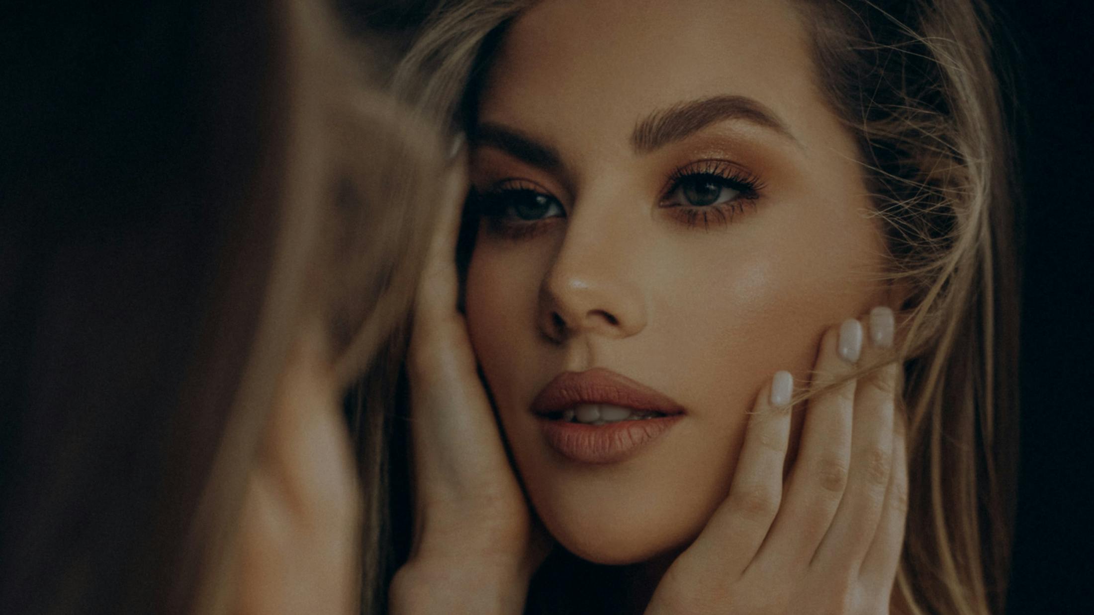 Close-up of a woman's face in the mirror