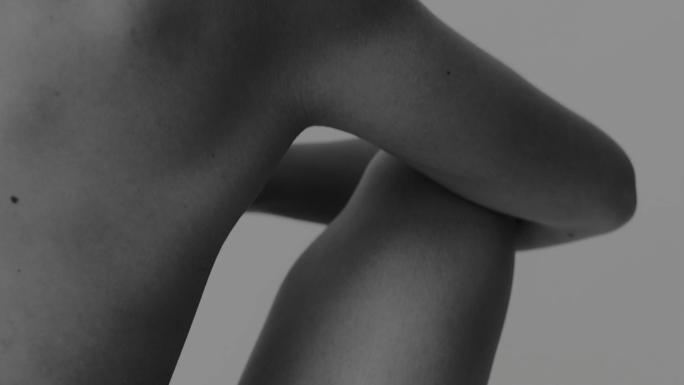 Black and white image of an arm and a leg