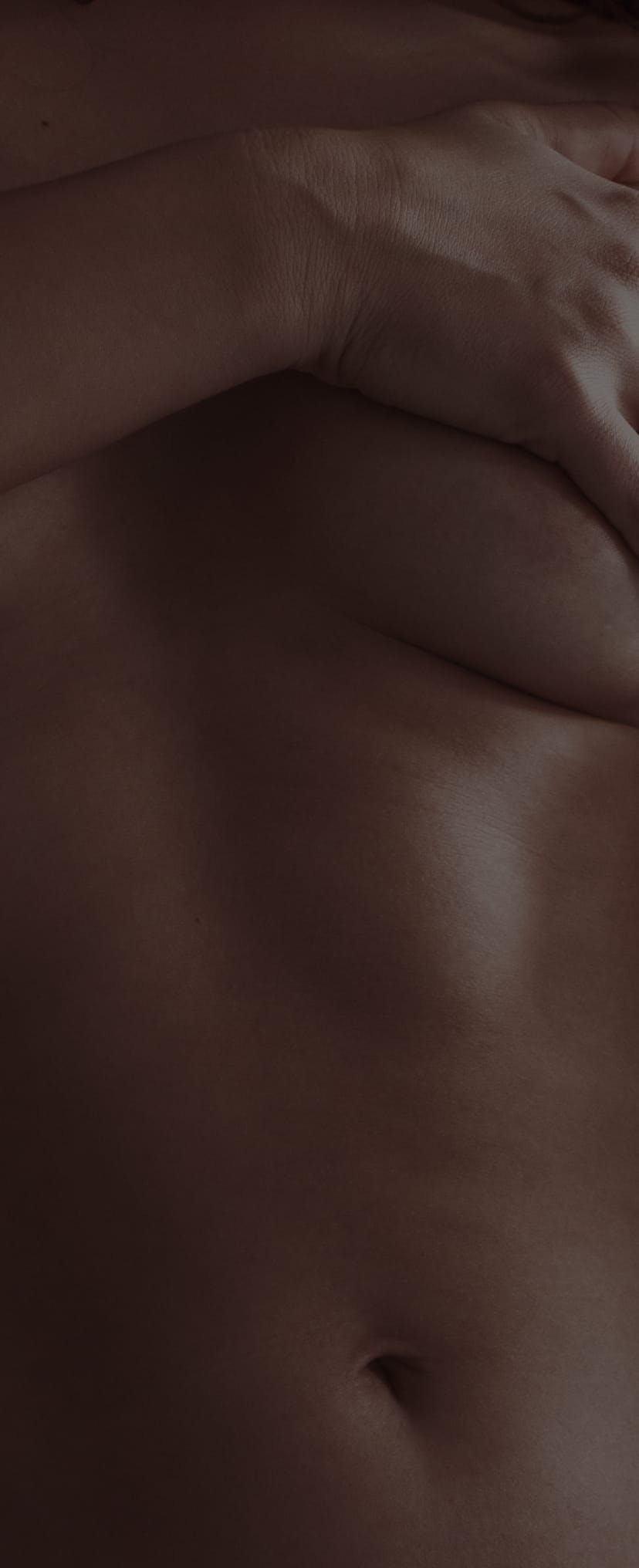 Close-up of a naked woman covering her breast