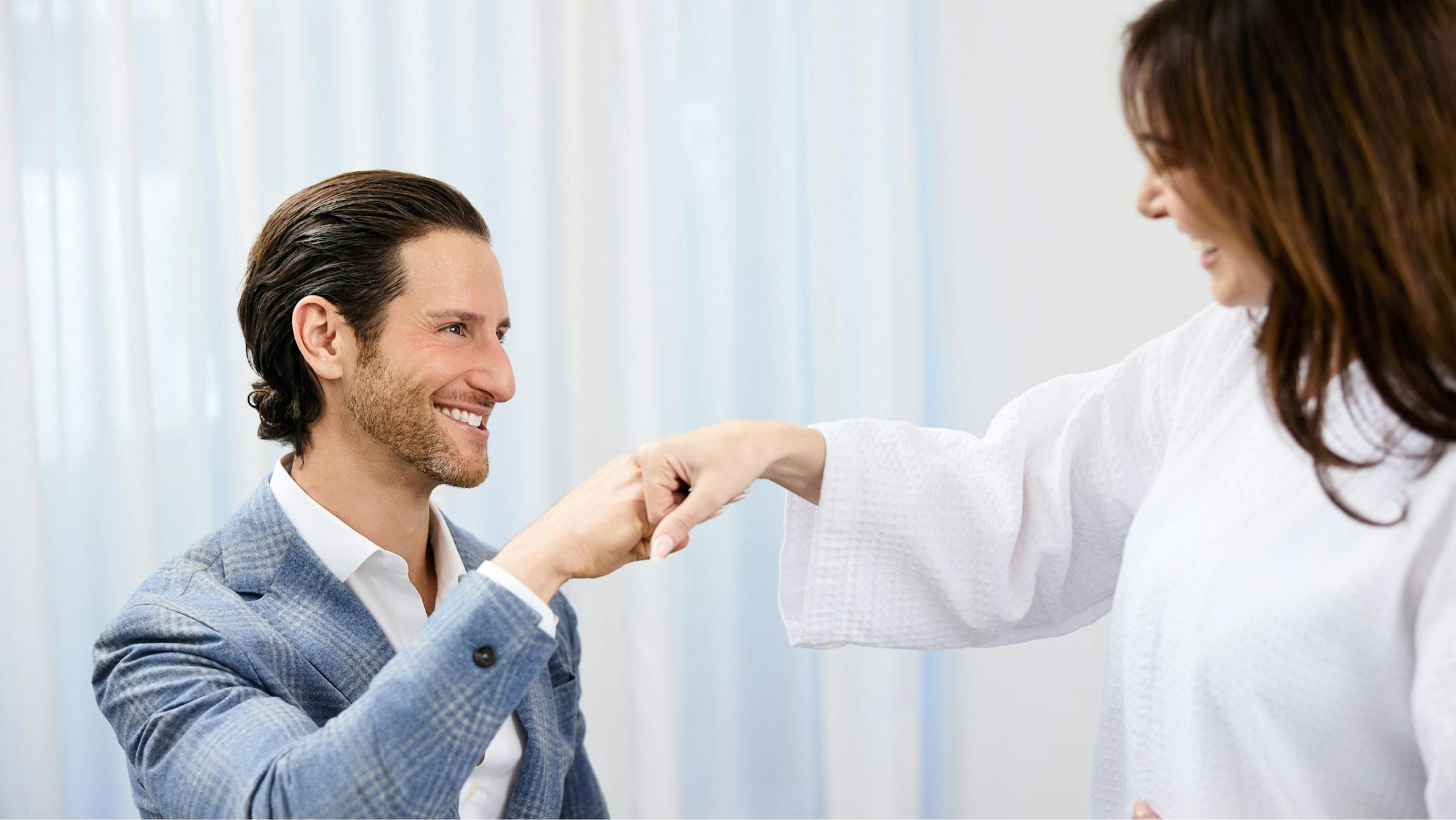 Dr. Unger fist bumping a patient