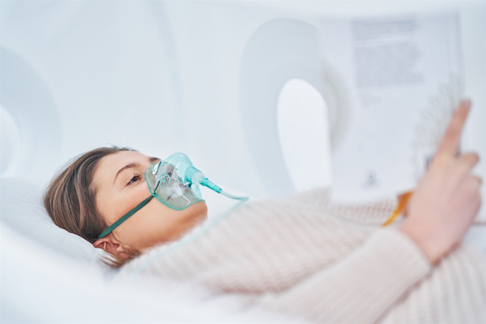 brunette woman in oxygen chamber