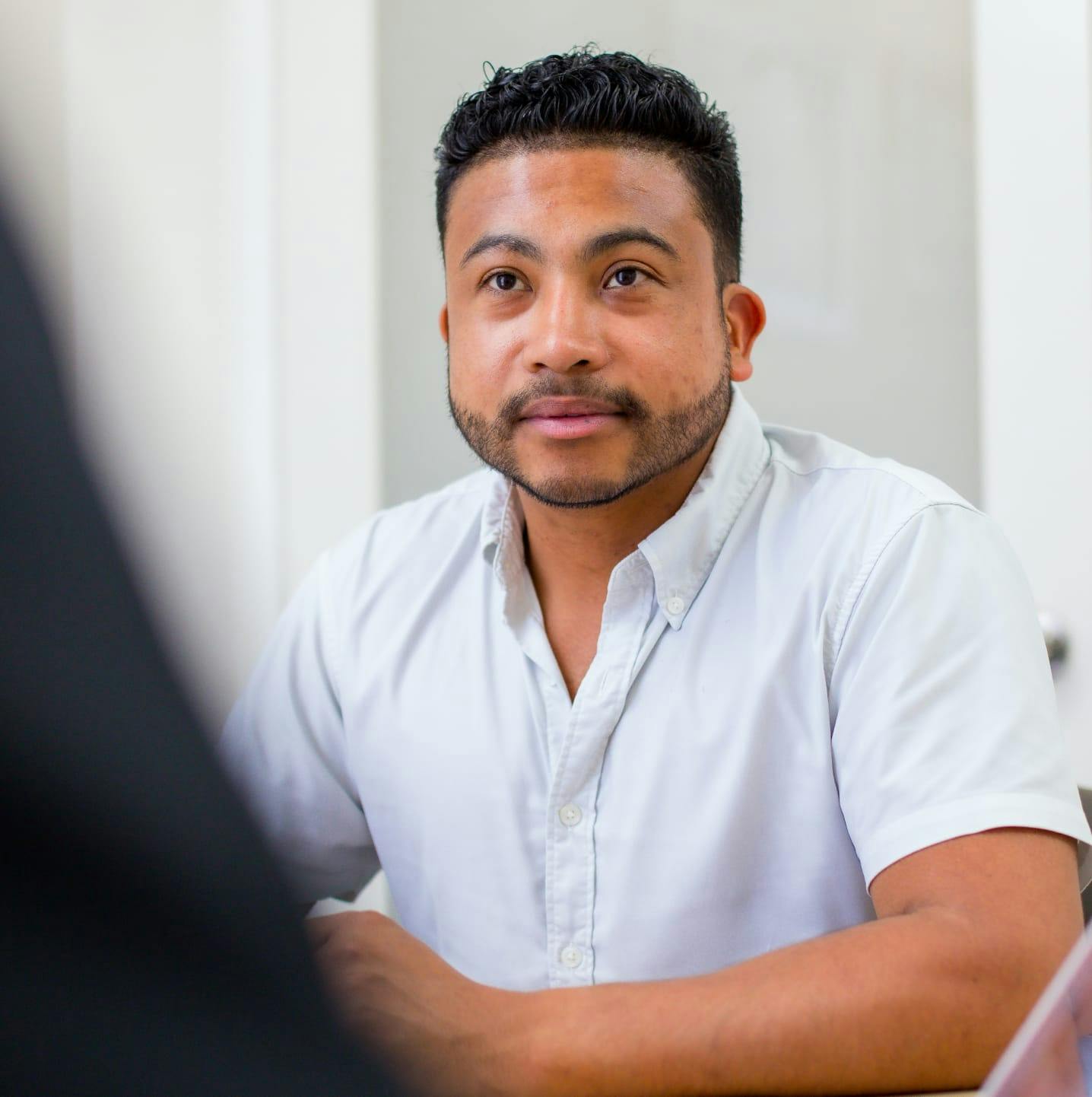 A man meeting with the hair transplant specialist in Delray Beach.
