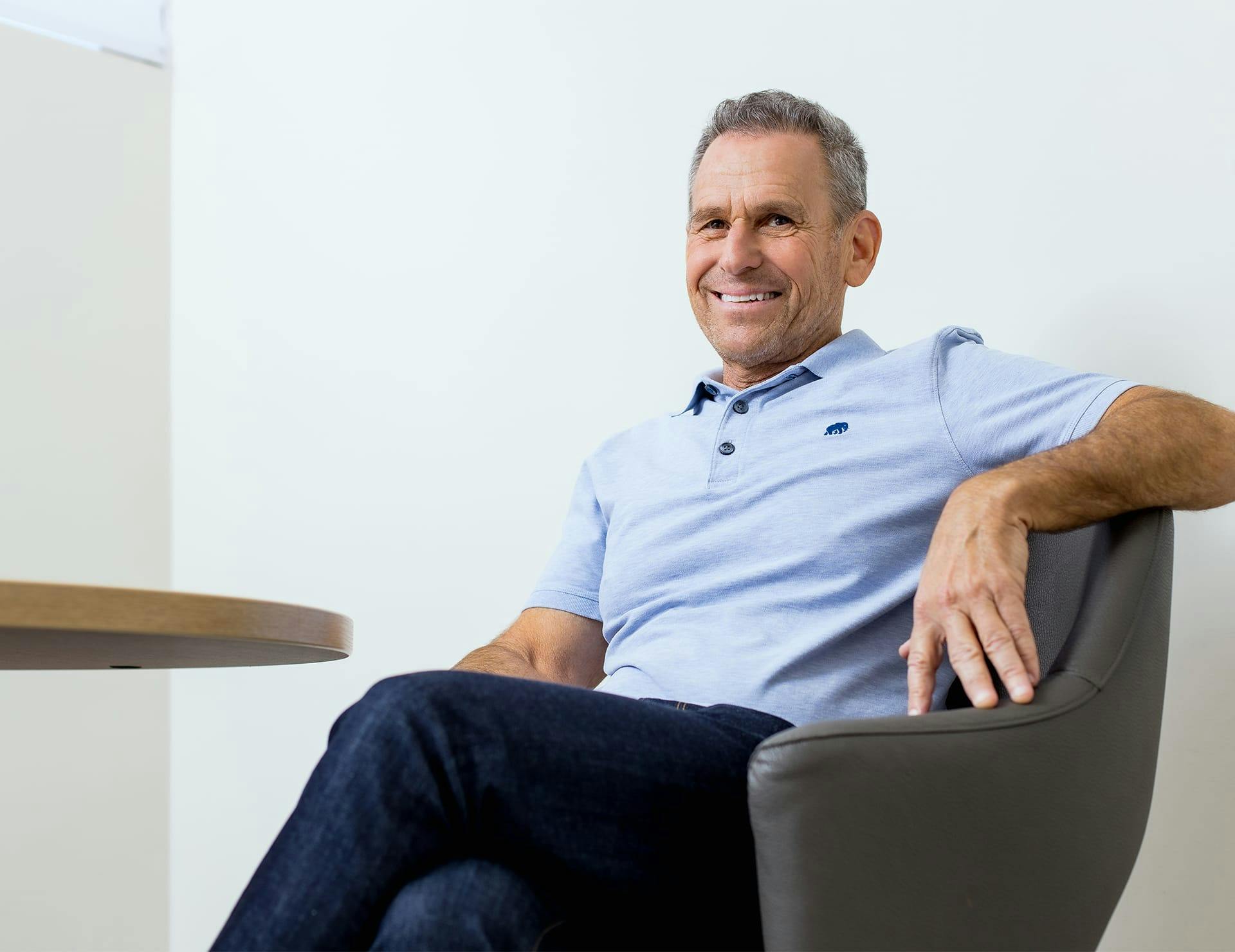 man sitting in chair smiling