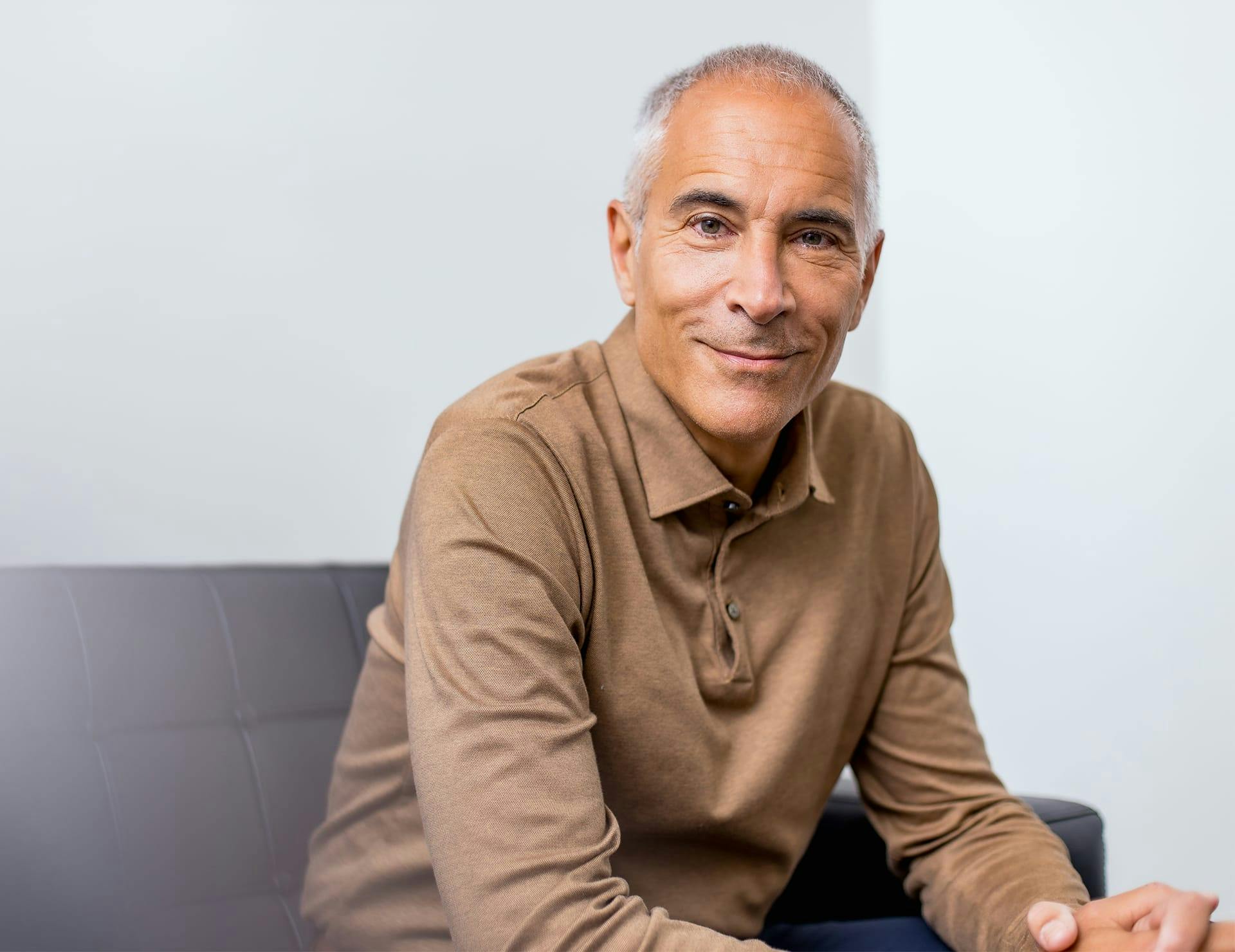 Dr. Jeffrey Epstein sitting on couch