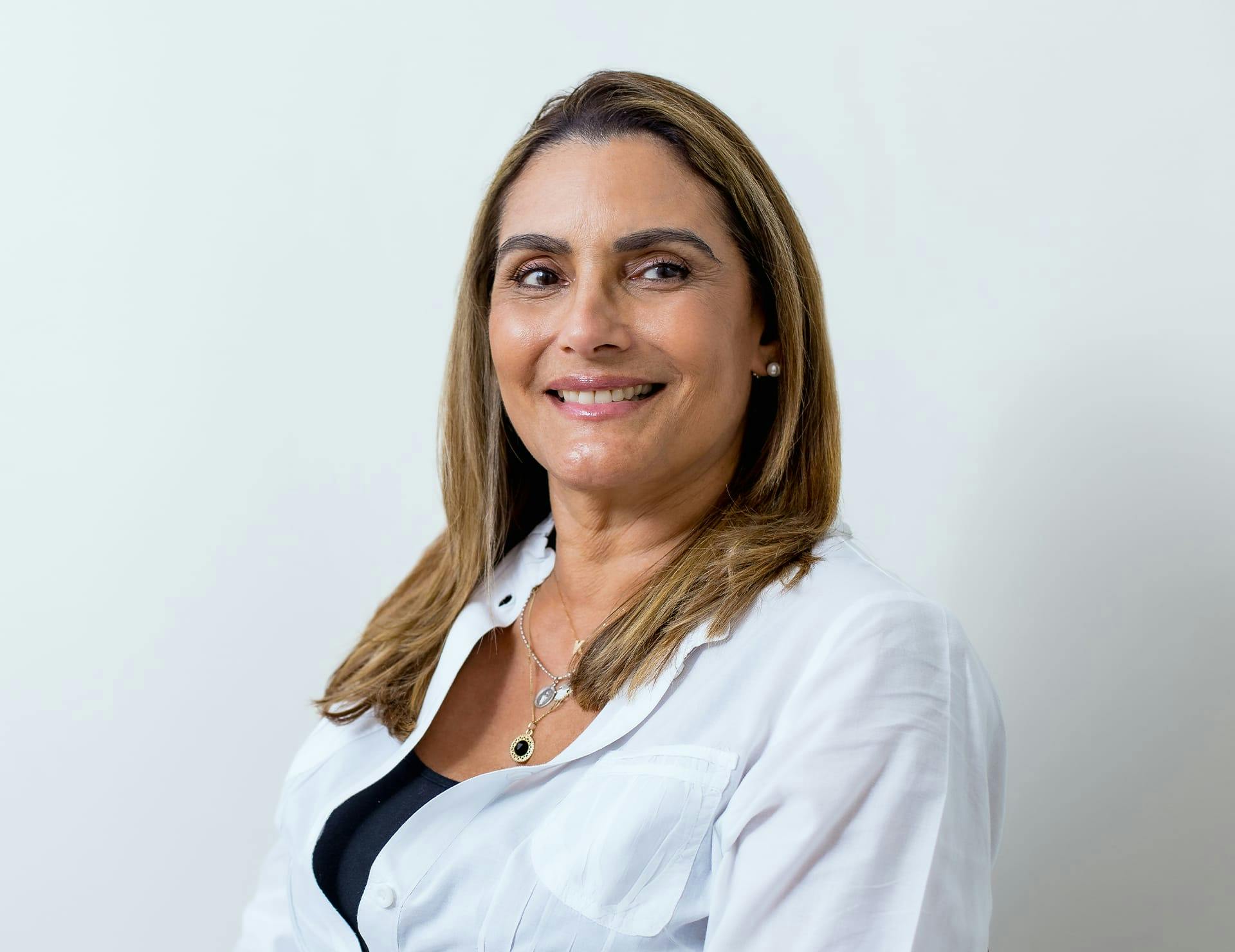A woman smiling after hair line lowering in Miami.