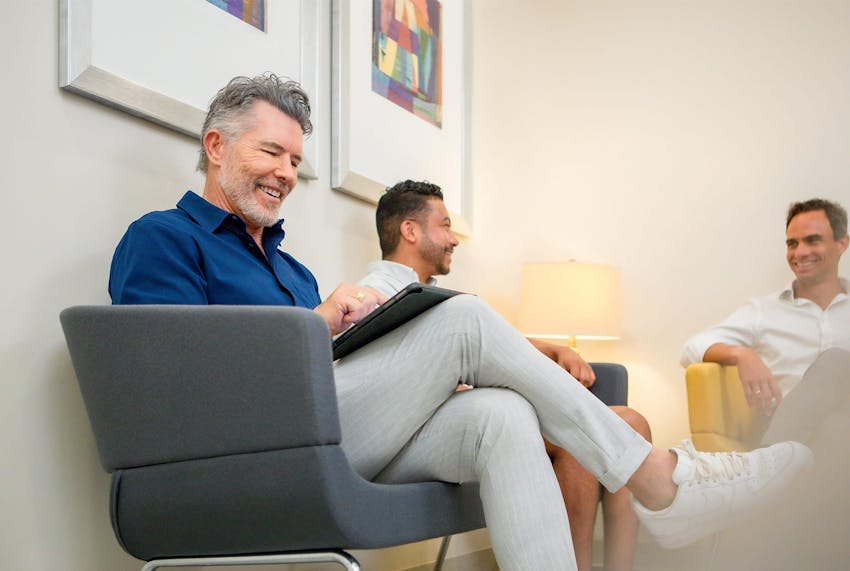 male clients sitting in waiting room together