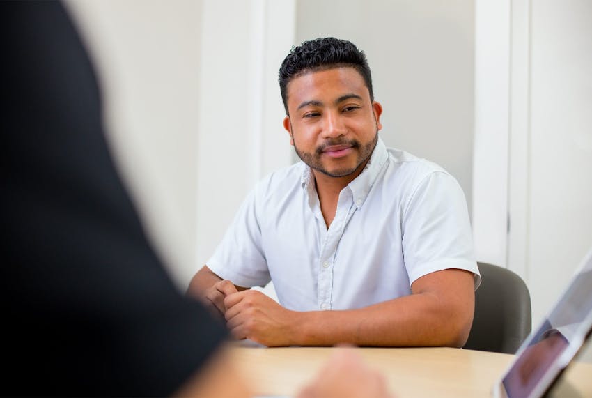 client in white shirt looking at ipad