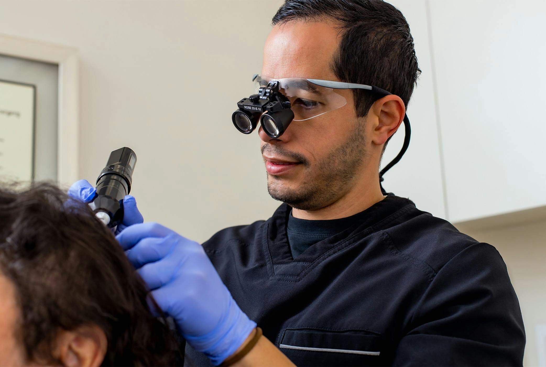 Daniel doing laser therapy on client