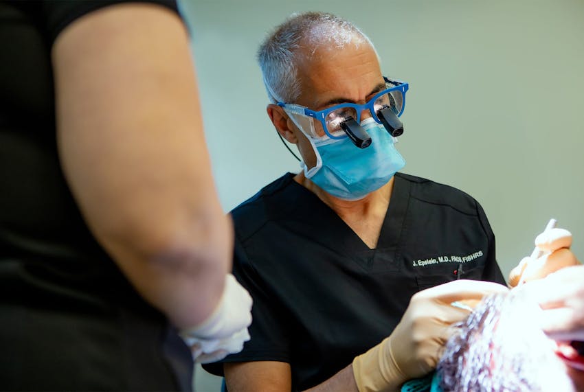 Jeffrey doing hair extraction on male client
