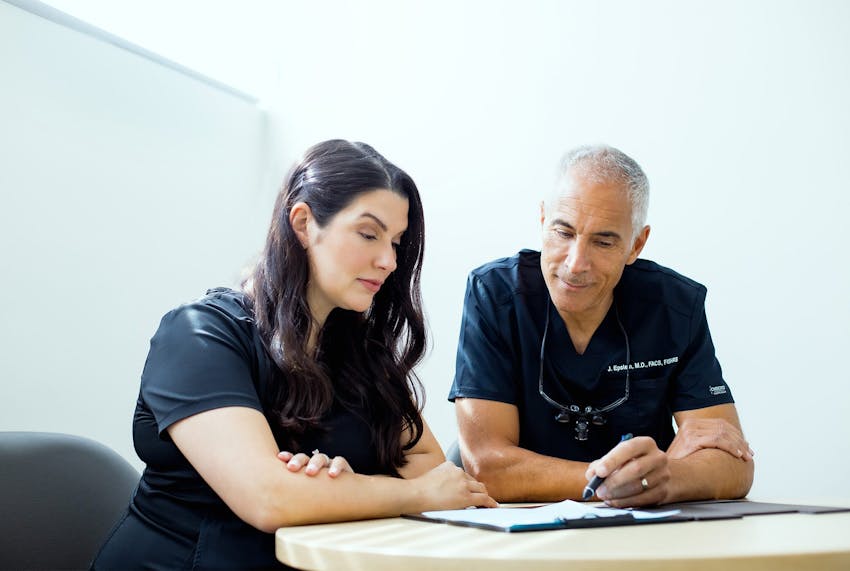 Jeffrey with client looking at paperwork together