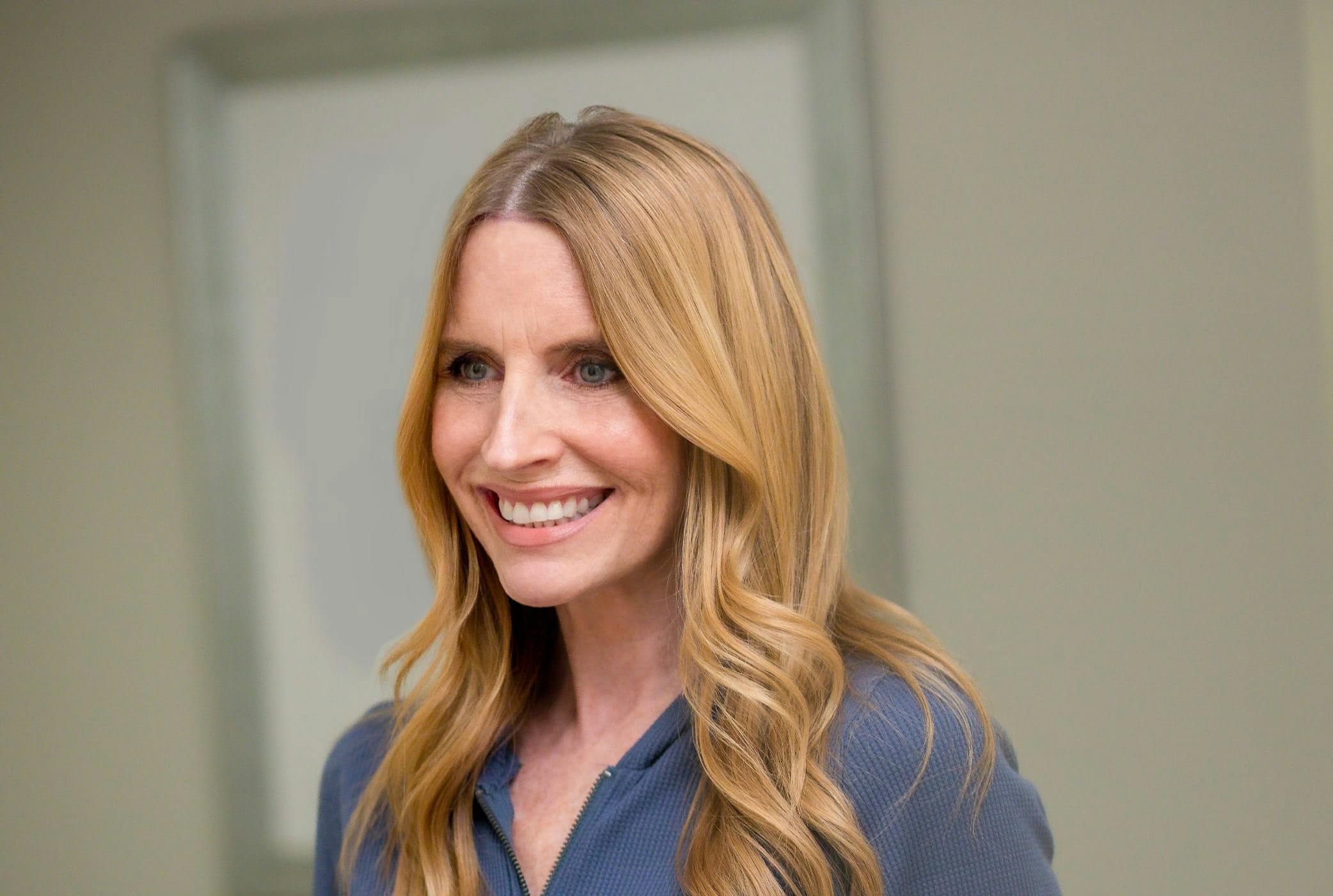 woman with blondish hair smiling