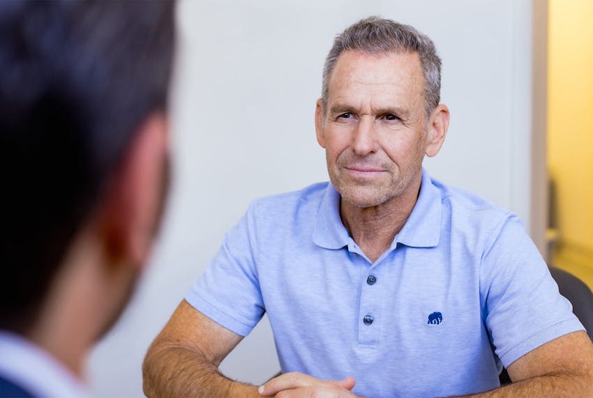 male client speaking to doctor across from him