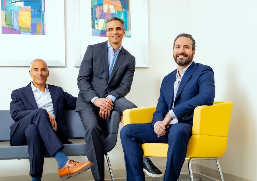 3 doctors sitting together all in suits