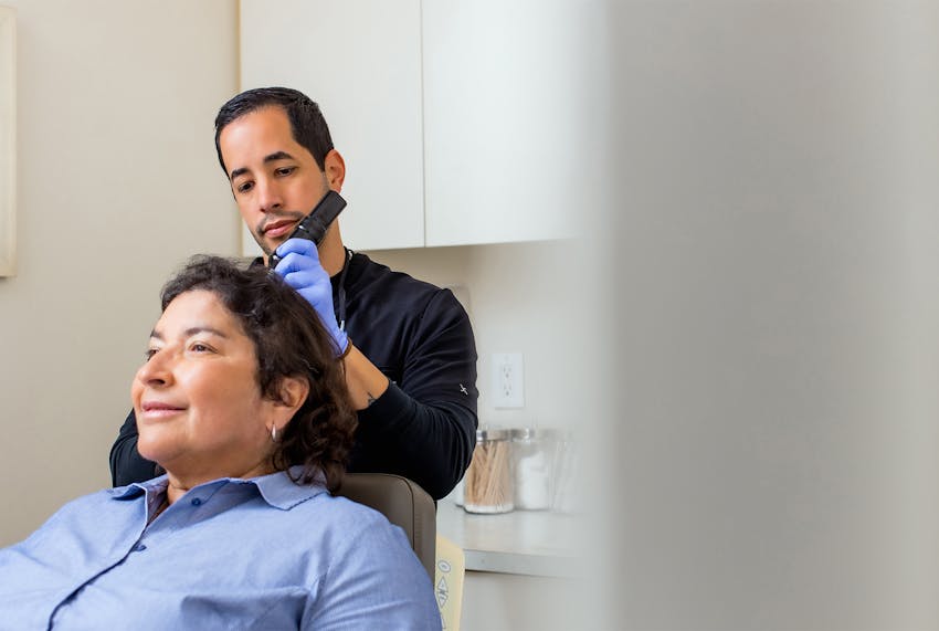 Daniel Crane in suit speaking to client