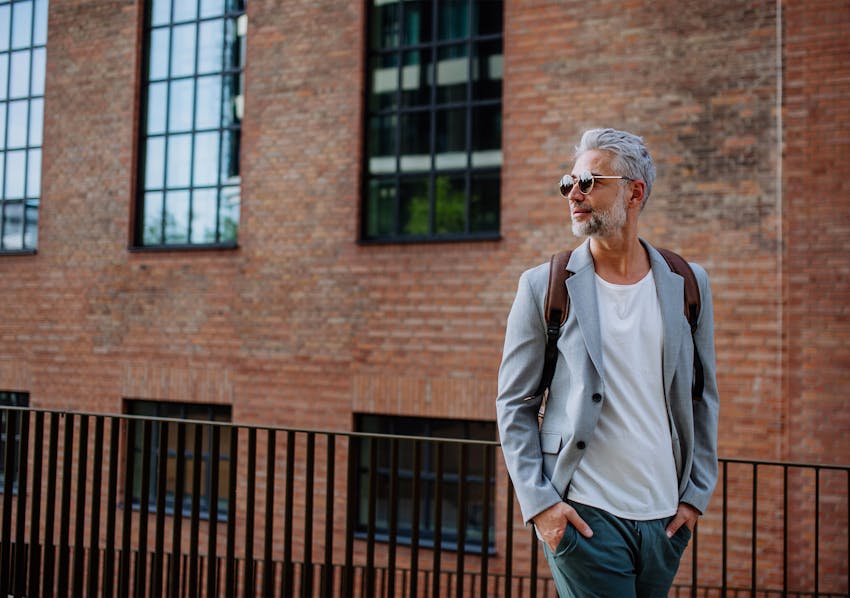 man in white collared shirt looking to the left