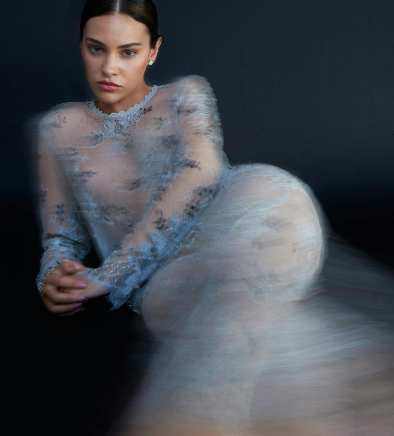 blurry image of a woman wearing a lacey outfit