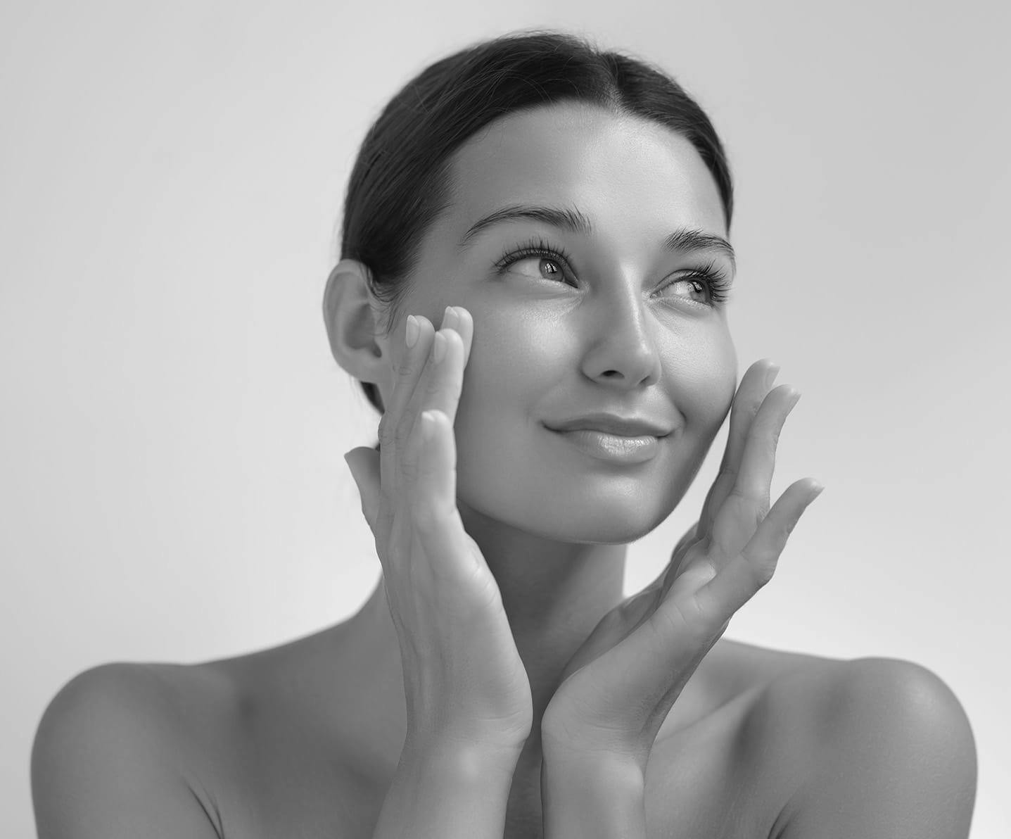 woman touching her cheeks