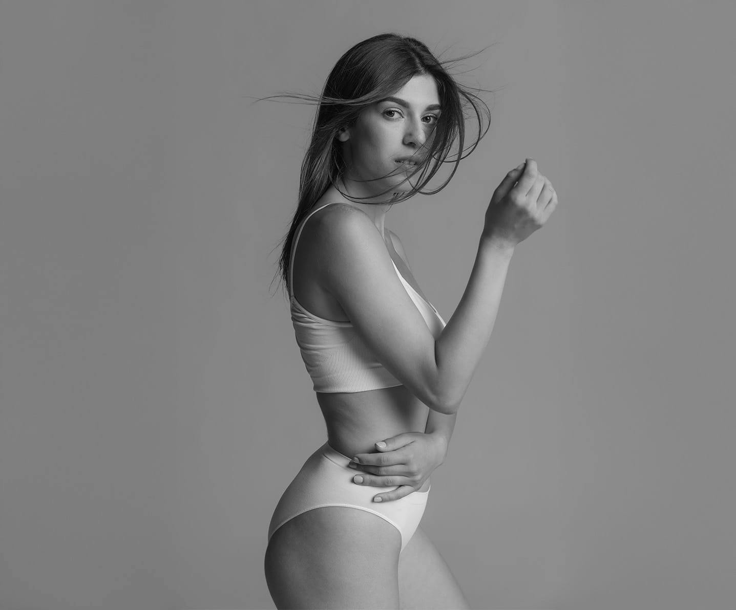 woman crossing her arm over her stomach