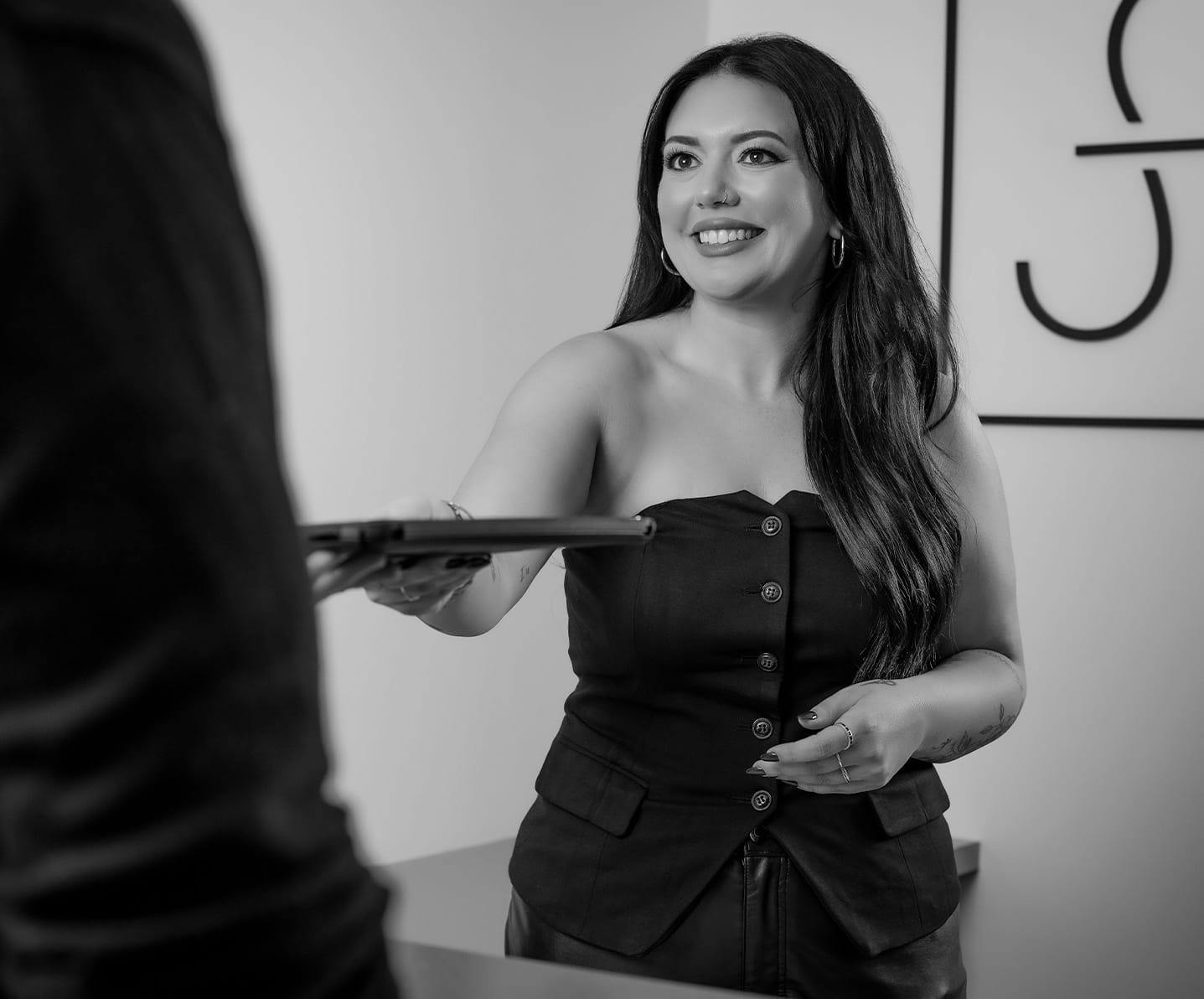 woman handing a tablet to a man