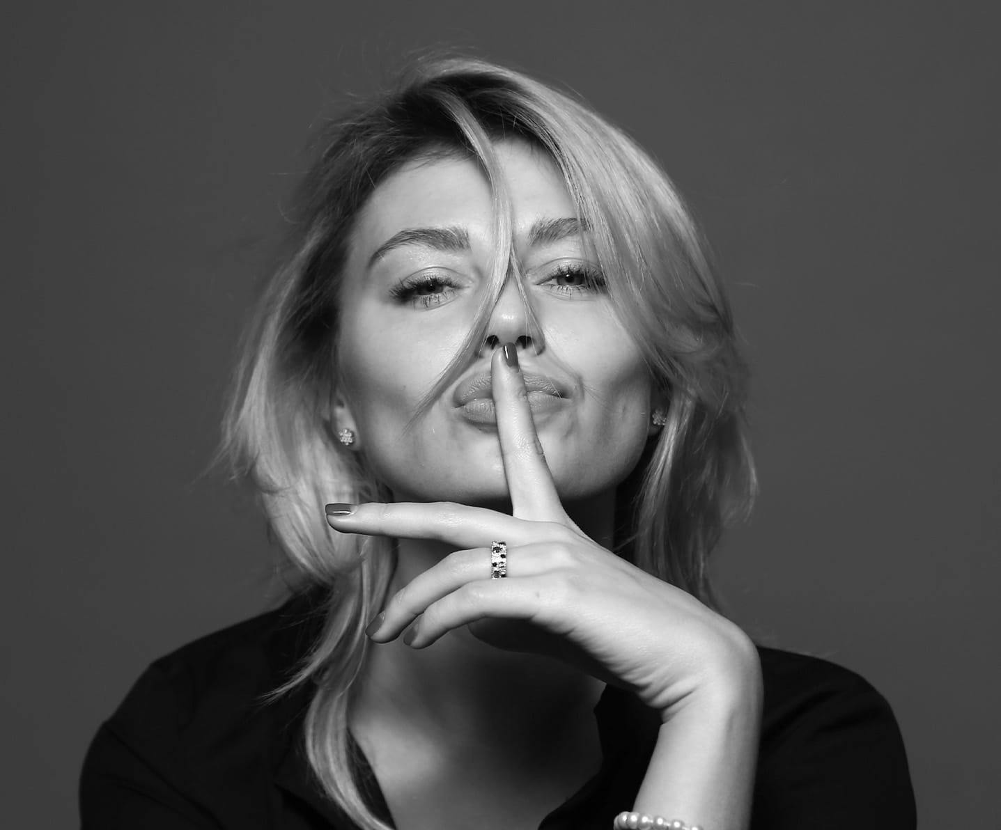 woman with her finger on her lips