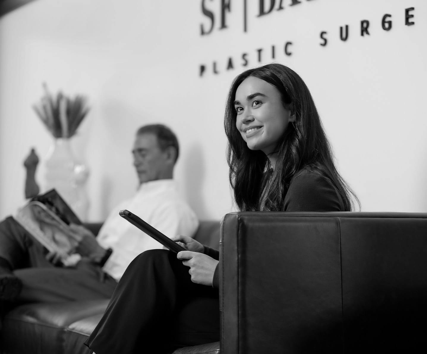woman sitting on a couch with an ipad
