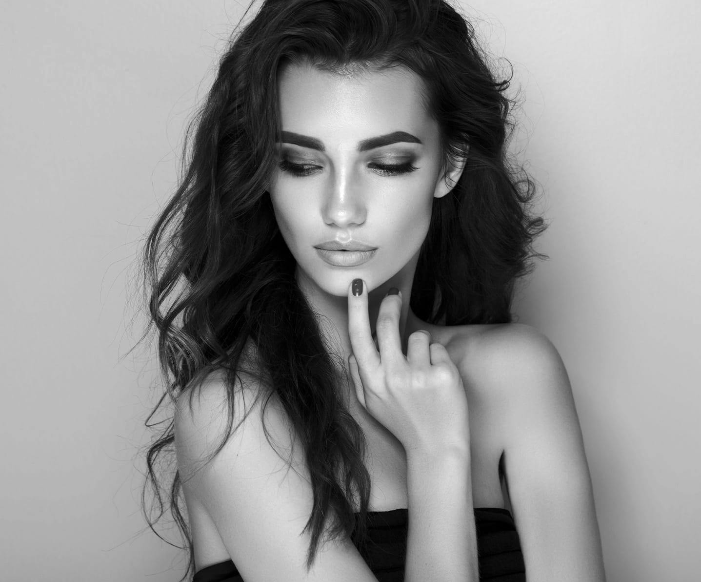 model touching chin looking down