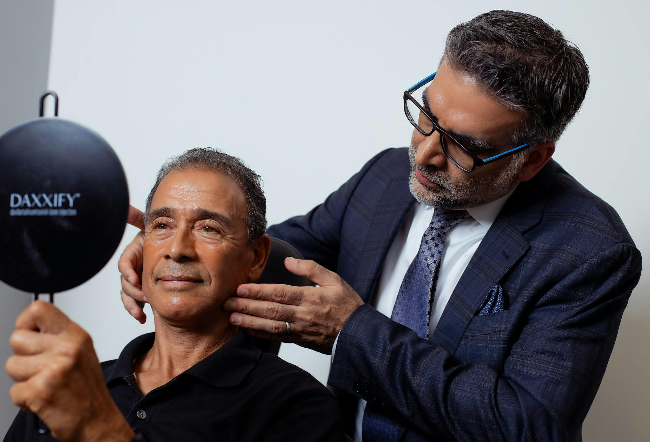 doctor showing a patient his face