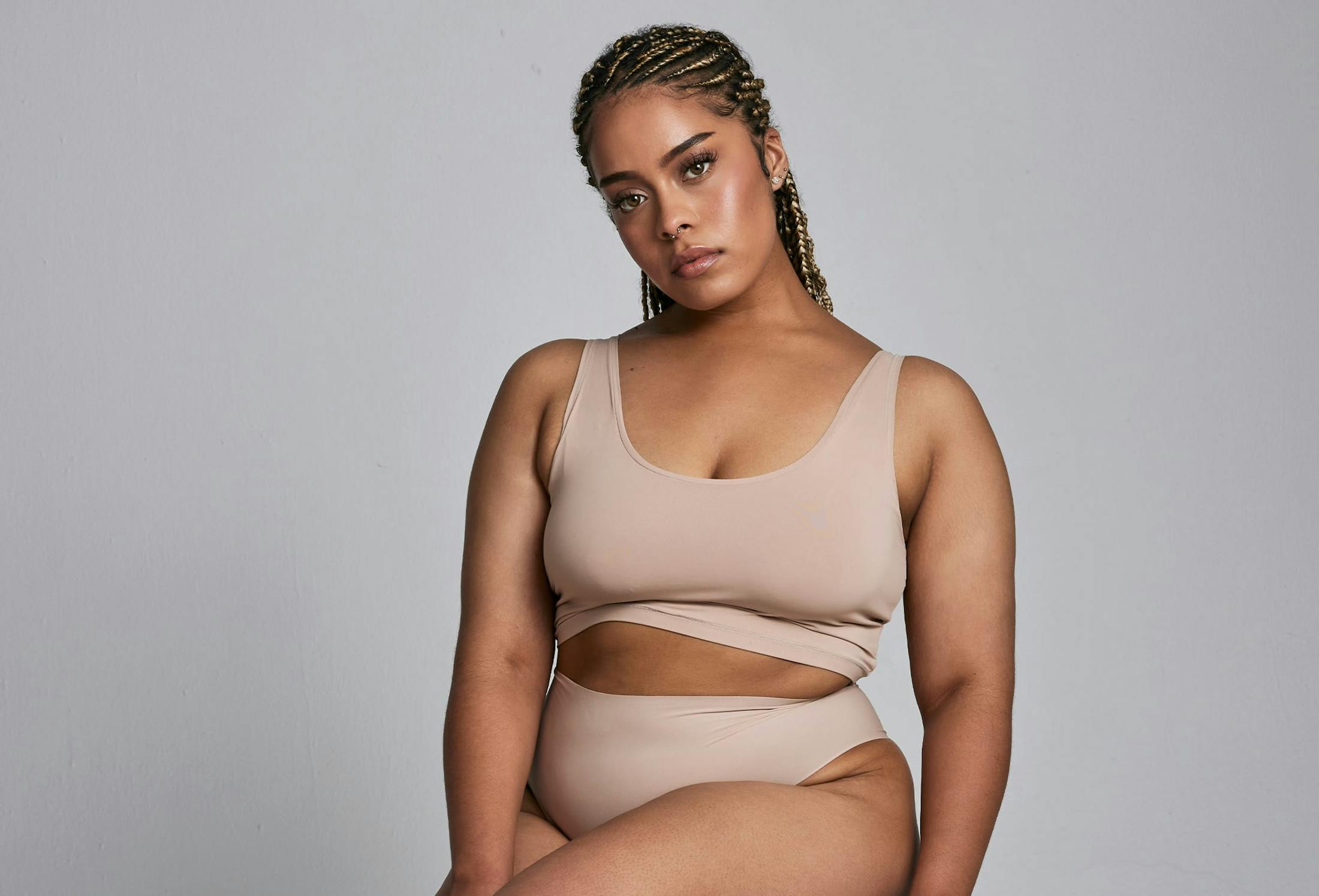 woman staring at camera infront of grey background