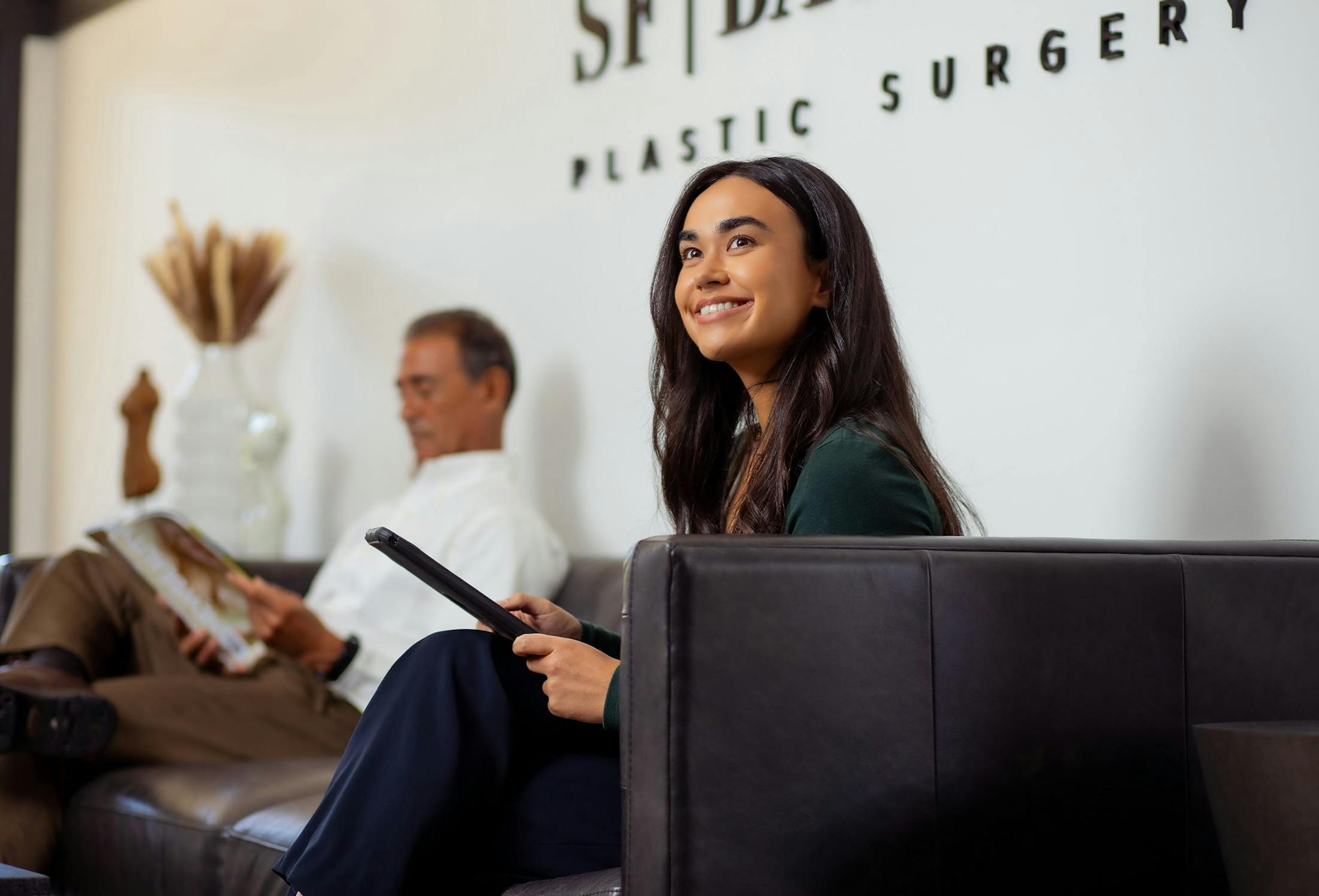 woman sitting on a couch with an ipad