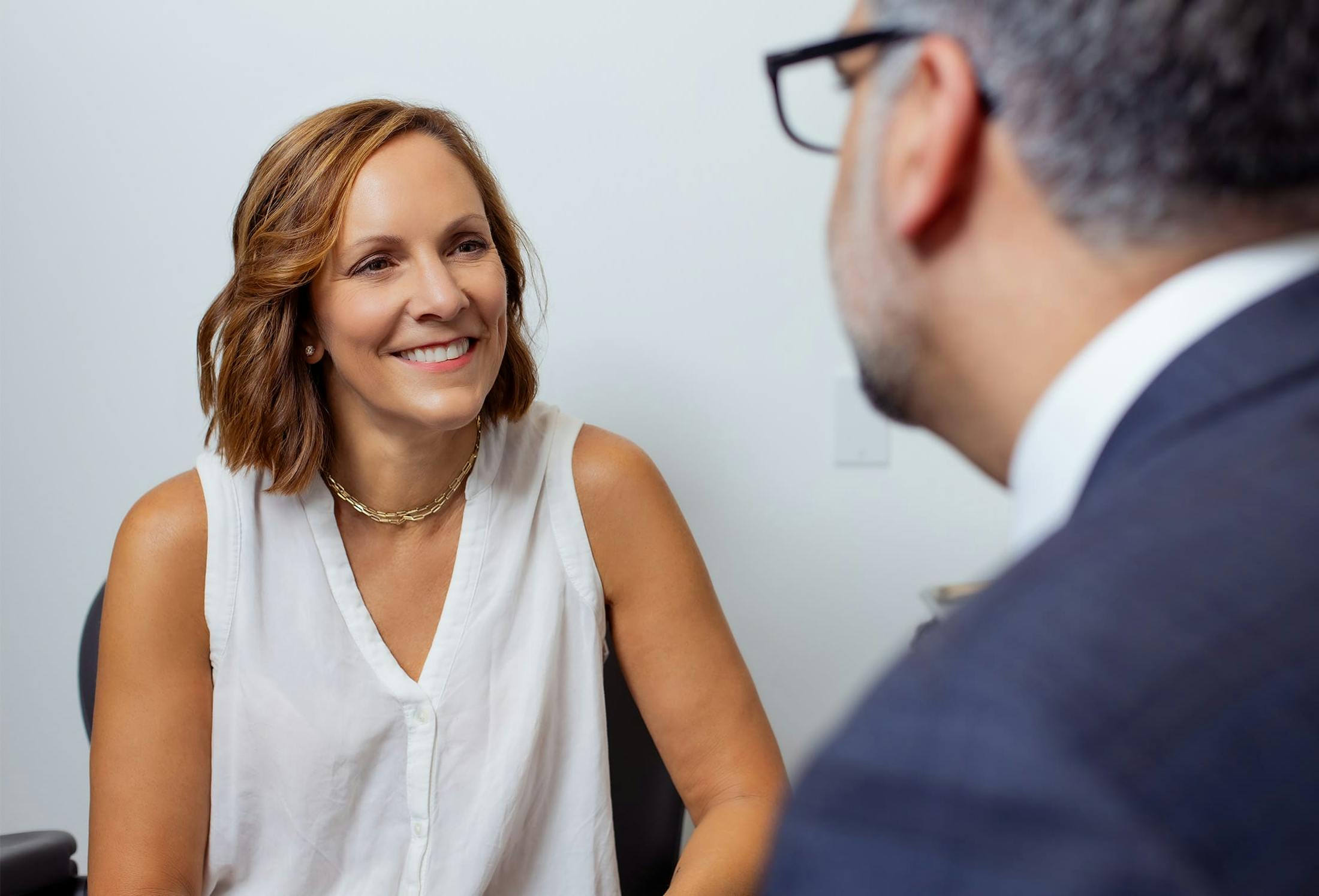 middle aged woman smiling at doctor