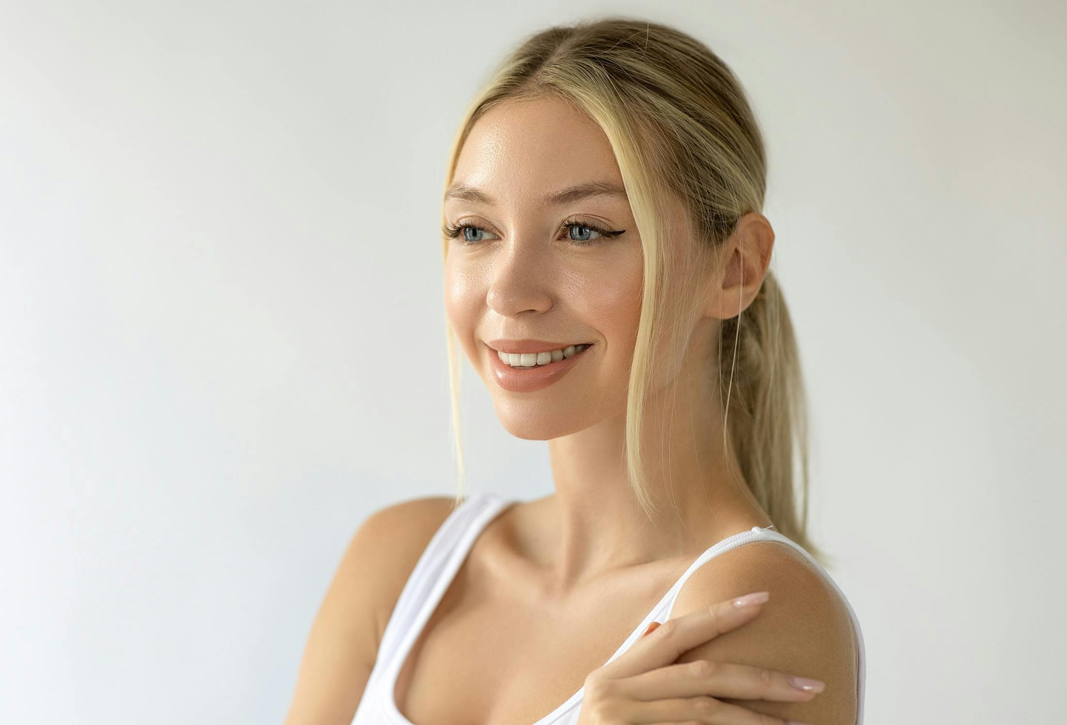 woman touching her shoulder