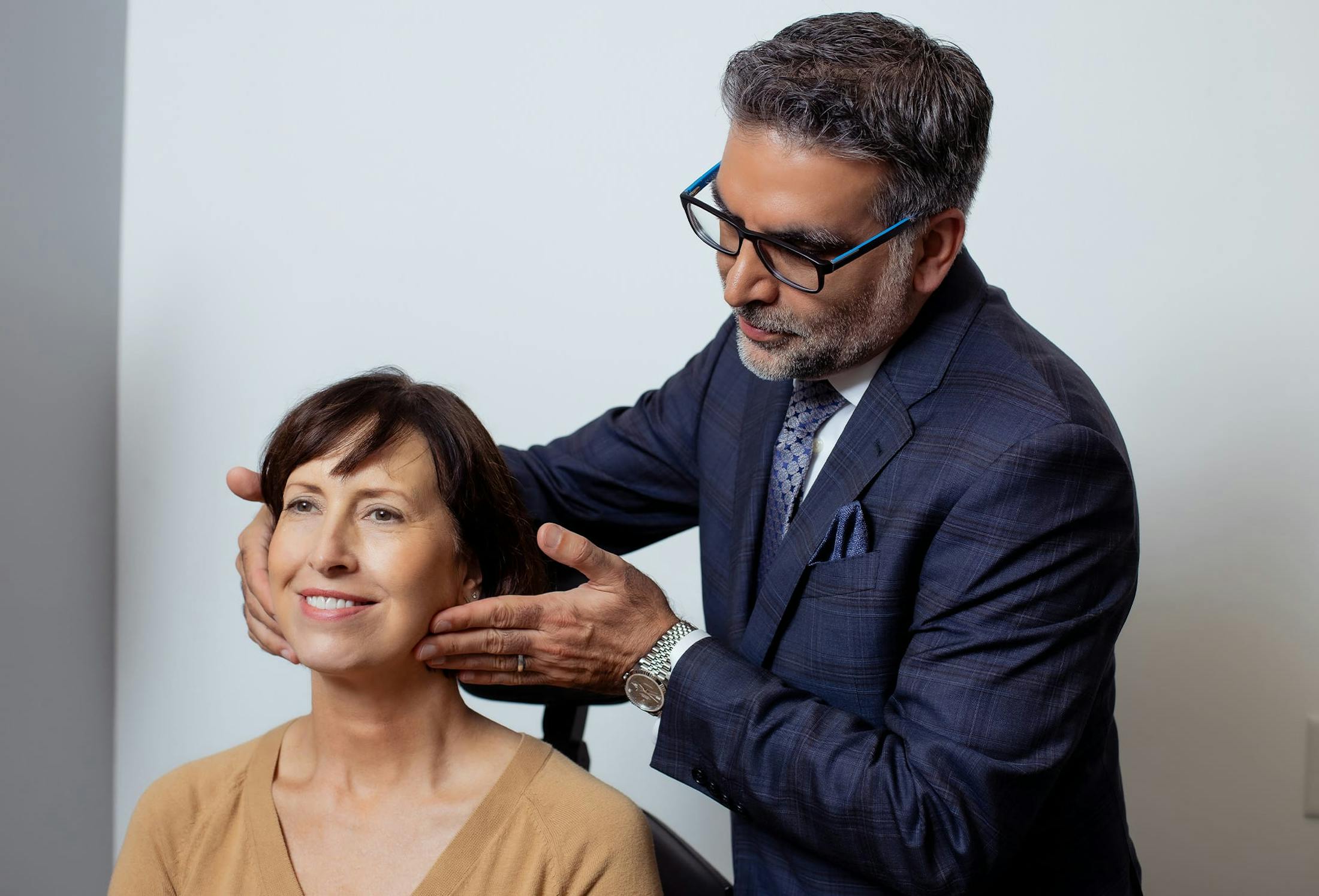 doctor holding patients face