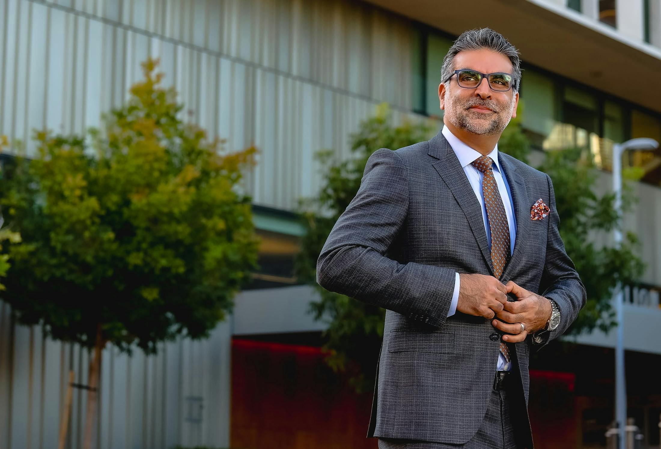 Dr. Fazilat standing outside, buttoning his jacket
