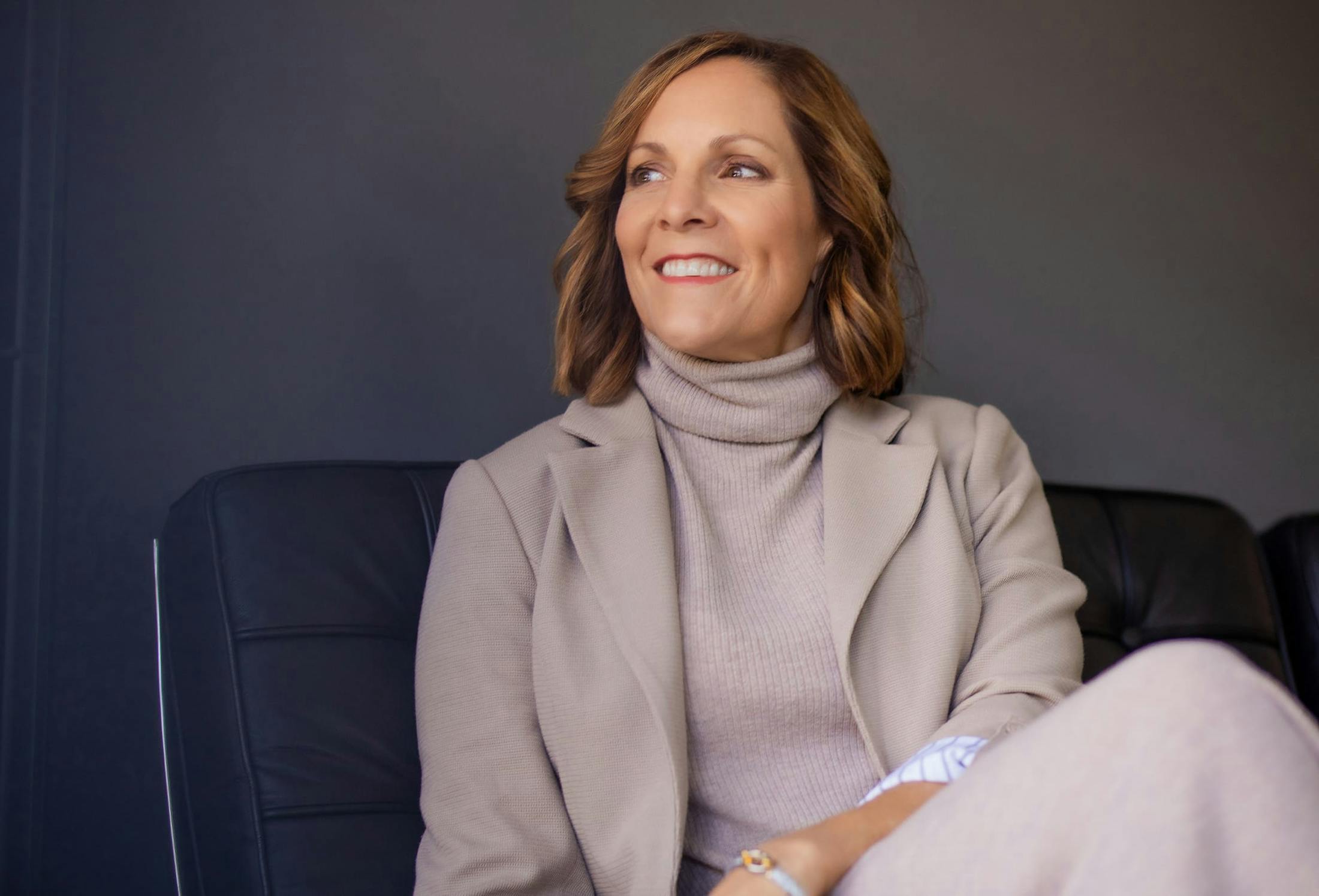 smiling woman sitting on a couch