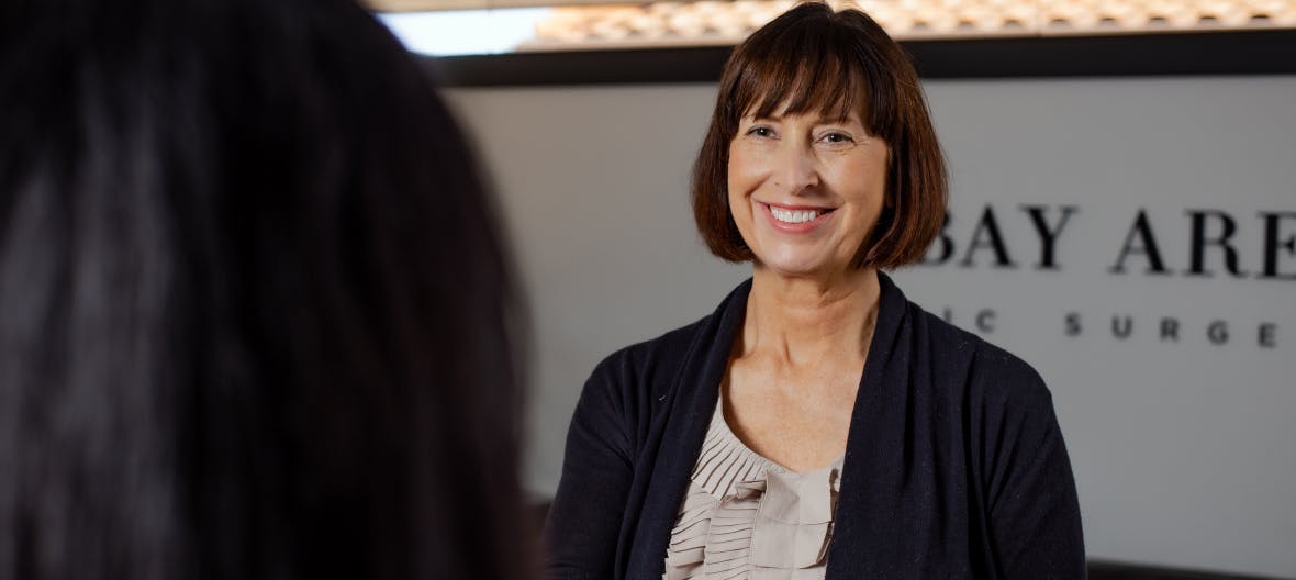 woman with short brown hair with bangs