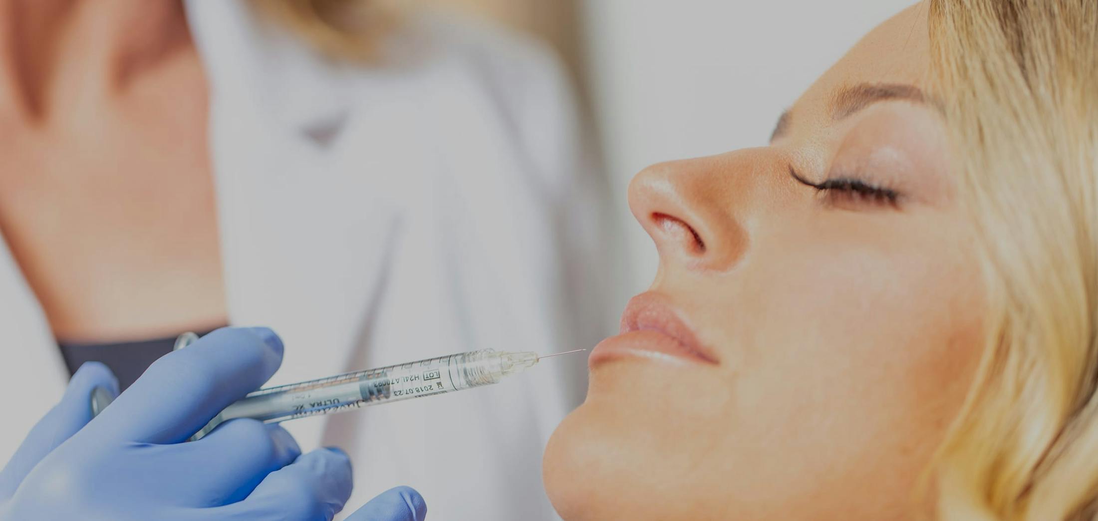 Woman recieving cosmetic injections in her lips