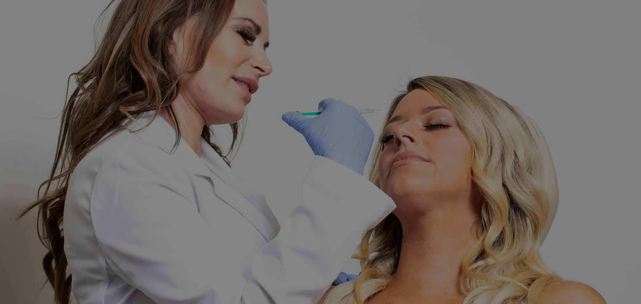 Woman recieving cosmetic injections in the forehead area