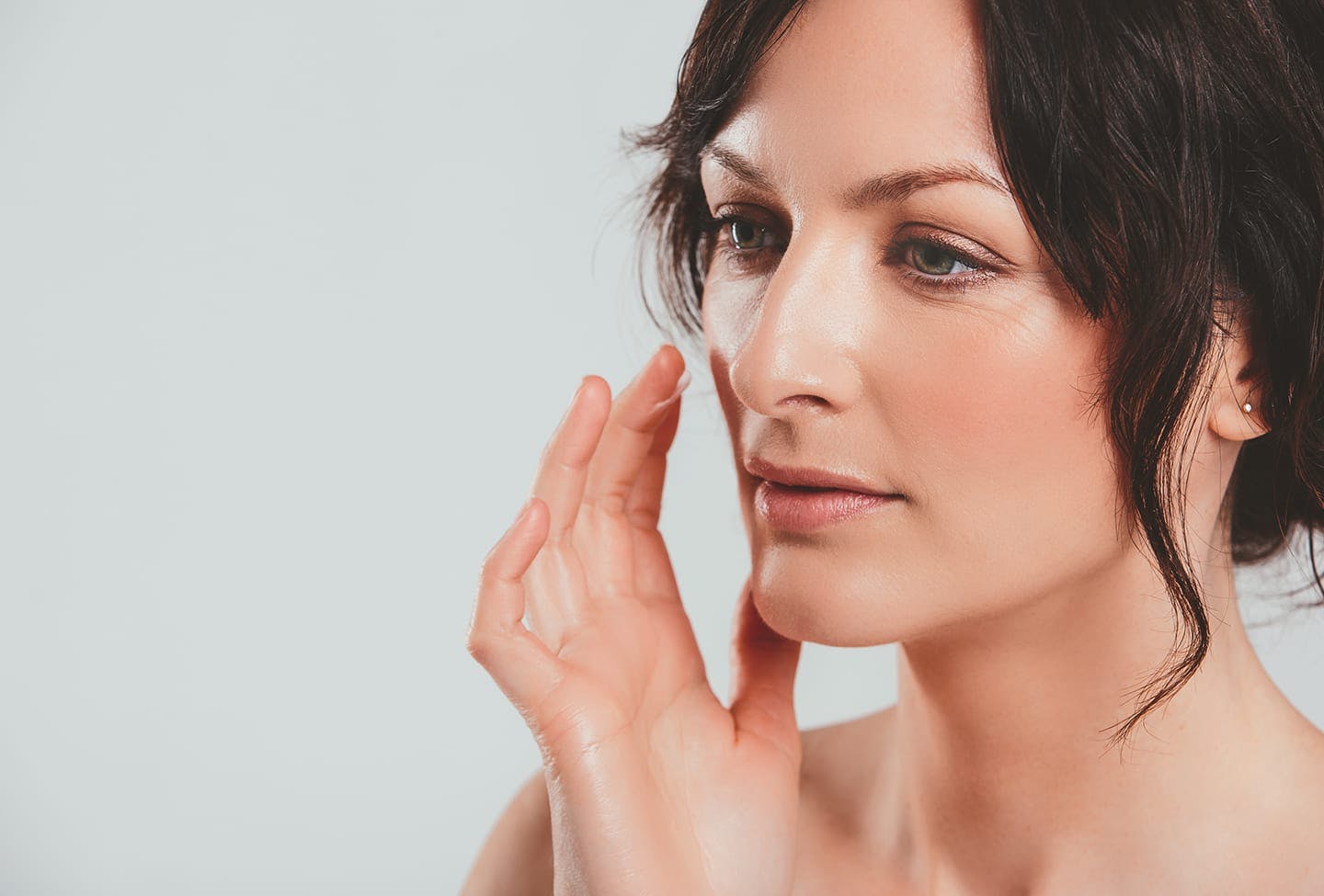 Face model putting cream on her face